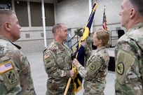 Soldiers pass the organizational colors during a change of command ceremony.