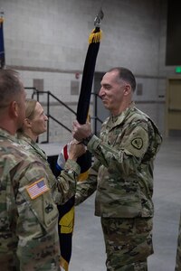 Soldiers pass the organizational colors during a change of command ceremony