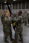 Soldiers pass the unit colors during a change of command ceremony
