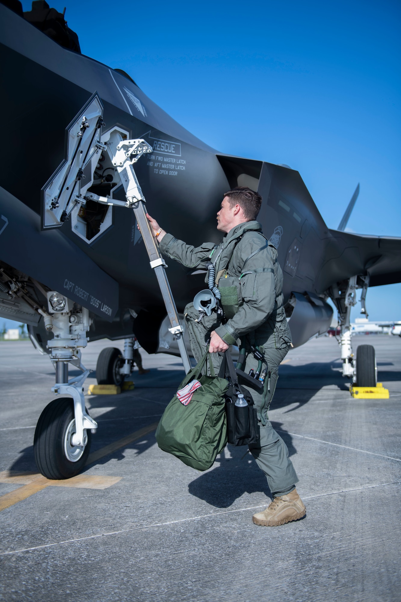 Man using a ladder to climb into a plane