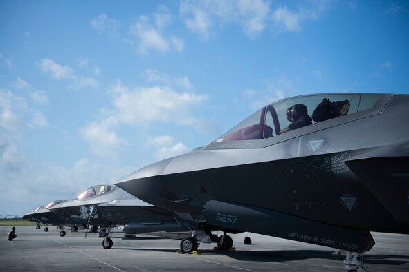 Side view of a man sitting in the cockpit of a plane