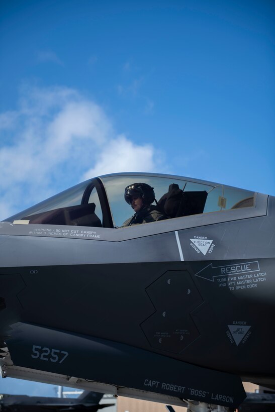 Side view of a man sitting in the cockpit of a plane