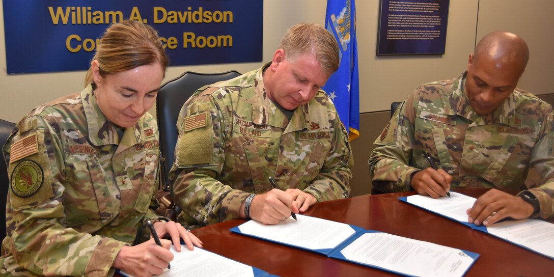 Left to right, Brig. Gen. Rebecca R. Vernon, Director, Military Justice and Discipline, The Air Force Judge Advocate General Corps; Brig. Gen. Terry L. Bullard, Commander, Office of Special Investigations; and Brig. Gen. Roy W. Collins, Director of Security Forces, Deputy Chief of Staff for Logistics, Engineering and Force Protection, sign a joint memorandum at OSI Headquarters May 24, 2021, implementing a fully integrated Criminal Investigation and Prosecution (CIP) capability. (U.S. Air Force photo by SA Spencer King)