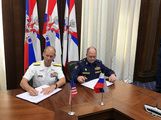 Rear Adm. Shawn Duane, left, head of the U.S. delegation, shakes hands with his Russian counterpart after signing the INCSEA agreement in Moscow.