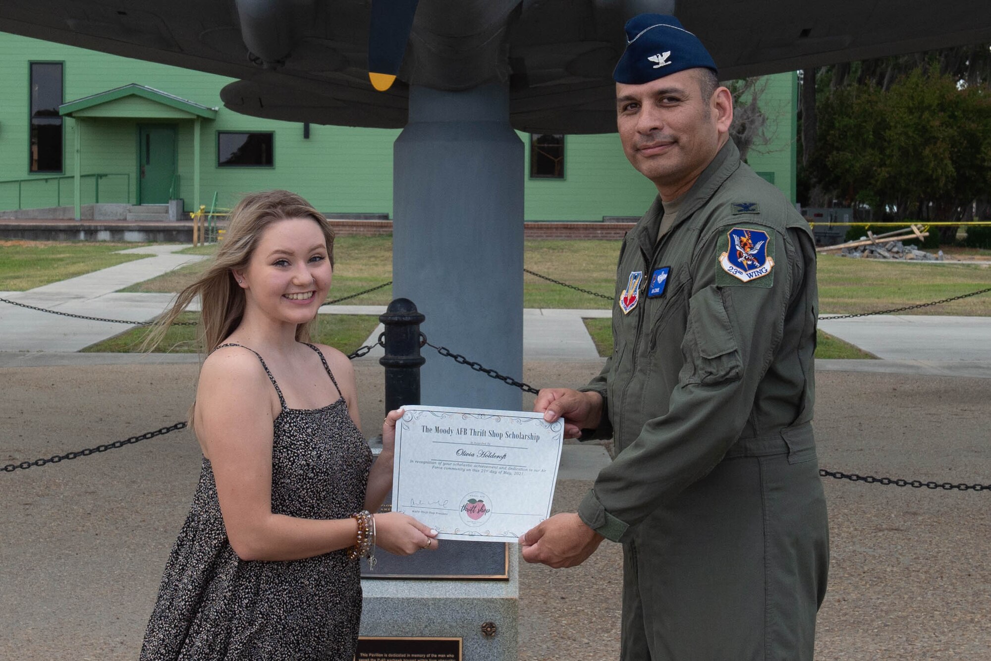 Airmen hands paper to military dependent.