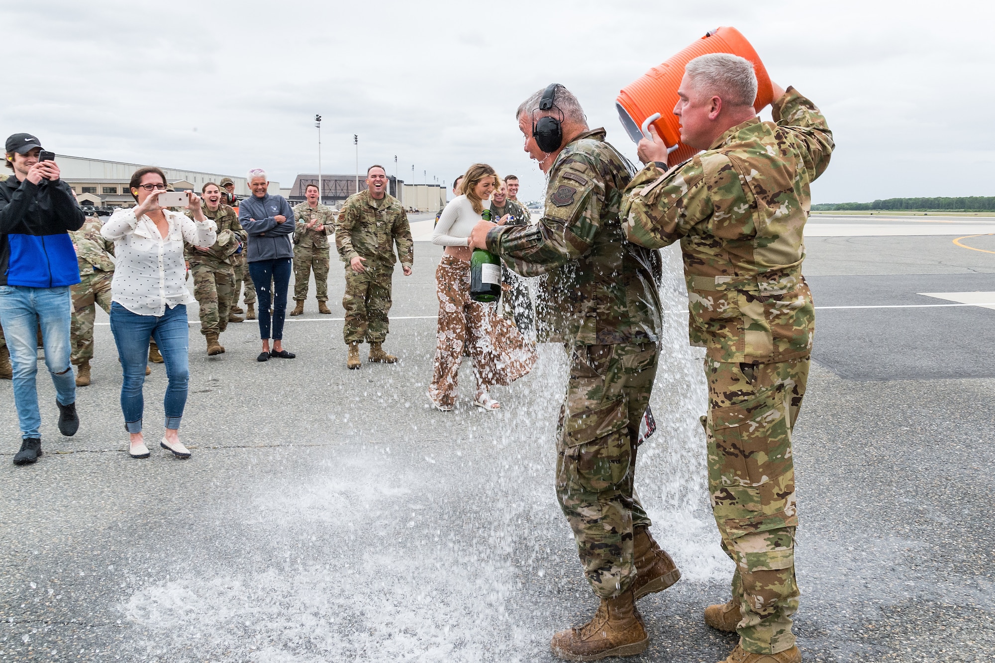 Col. Mike Peeler, right, 436th Operations Group commander, pours ice water on Col. Christopher May, 436th Maintenance Group commander, at Dover Air Force Base, Delaware, May 24, 2021. May received the traditional “fini flight” hose-down from family, friends and base personnel after the flight. May is retiring after serving 33 years in the Air Force. (U.S. Air Force photo by Roland Balik)