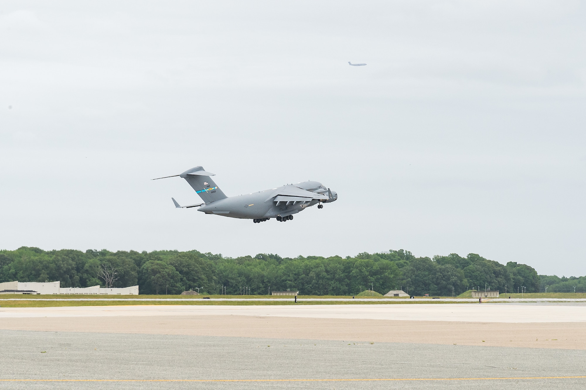 Col. Christopher May, 436th Maintenance Group commander, takes off as a passenger aboard a C-17 Globemaster III during his “fini flight” at Dover Air Force Base, Delaware, May 24, 2021. May received the traditional hose-down from family, friends and base personnel after the flight. He is retiring after serving 33 years in the Air Force. (U.S. Air Force photo by Roland Balik)