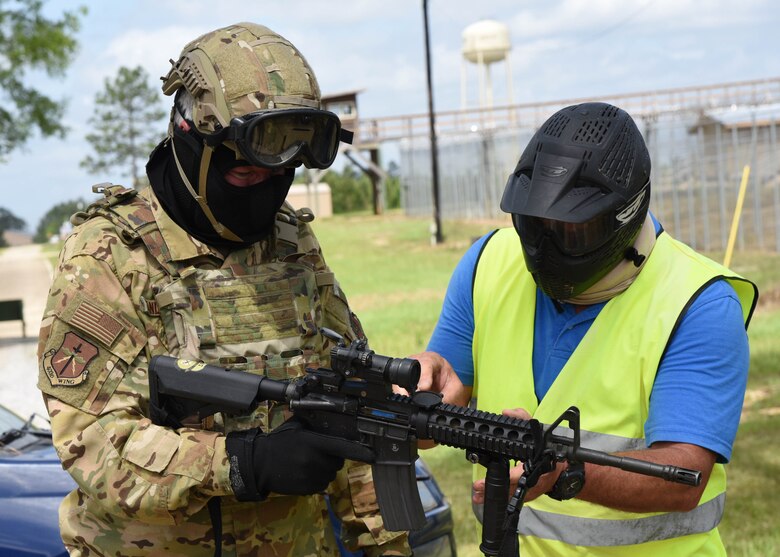 Col. Jeffrey A. Van Dootingh, 403rd Wing commander, checks his gear May 21, 2021.  Wing leaders and 403rd Security Forces Squadron members travelled to Camp Shelby Joint Forces Training Center in Hattiesburg, Miss., to participate in a number of different training exercises including a Shoot, Move, Communicate course, Engagement Skills Trainer virtual weapons firing, Squad Advanced Marksmanship training, and a Virtual Battlefield Systems convoy simulation. The trip was an opportunity for the Air Force Reserve Command unit leaders to become more familiar with the training capabilities available at the Mississippi Army National Guard base. Also, it allowed 403rd leadership a chance to strengthen relationships with training facility managers and personnel as well as Camp Shelby Commander, Col. Richard L. Weaver. (U.S. Air Force photo by Lt. Col. Marnee A.C. Losurdo)