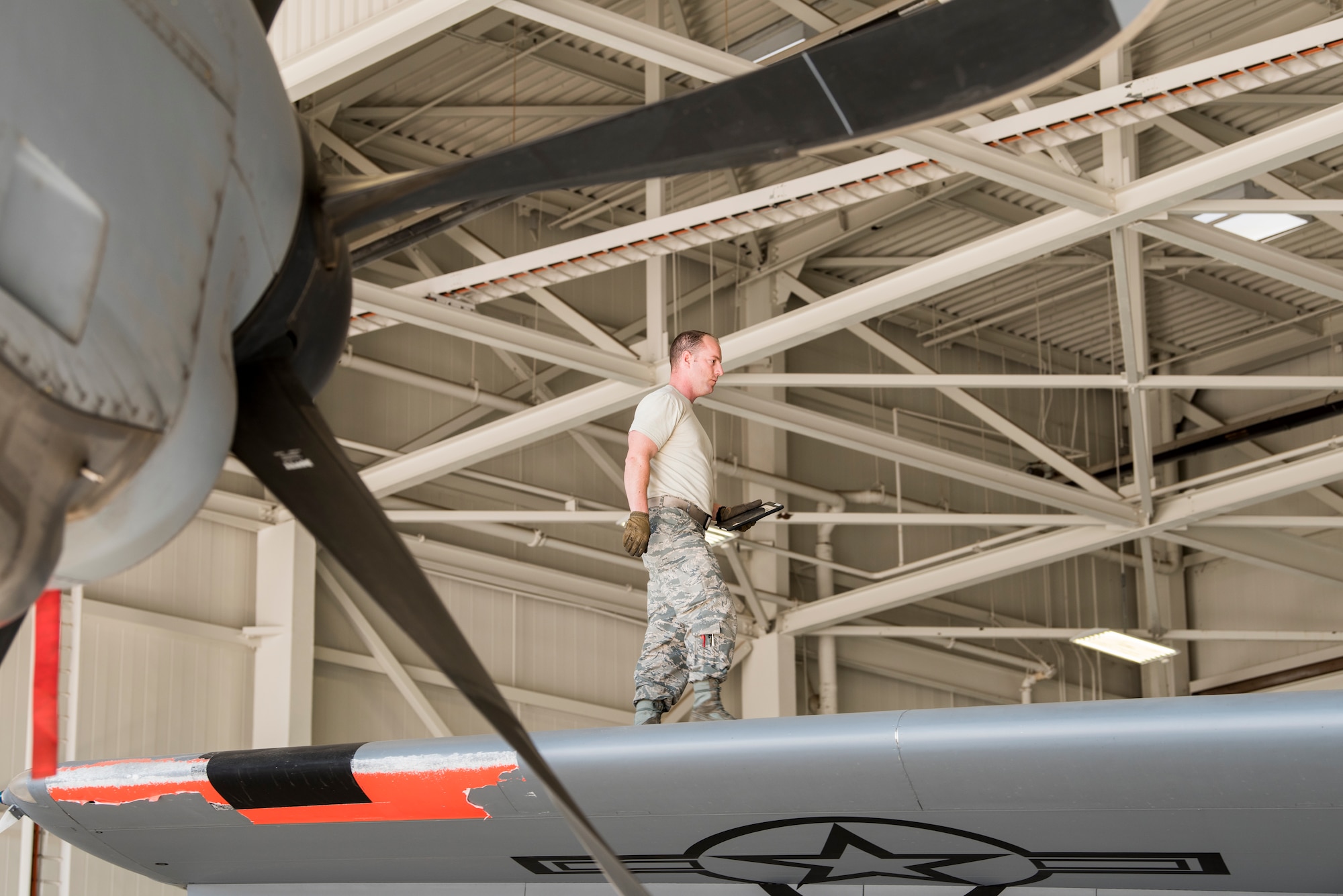 Staff Sgt. Timothy Dawson, a C-130J Hercules aircraft maintenance technician with the 146th Airlift Wing, walks the top of a C-130J during an inspection Dec. 13, 2017. Dawson�s three-level, 52-unit apartment complex burned to the ground as the Thomas Fire roared through his neighborhood. The 146 Airlift Wing was activated Dec.5, 2017, to support CAL FIRE with wildfire suppression efforts within the state. (U.S. Air Force photo/Master Sgt. Brian Ferguson)