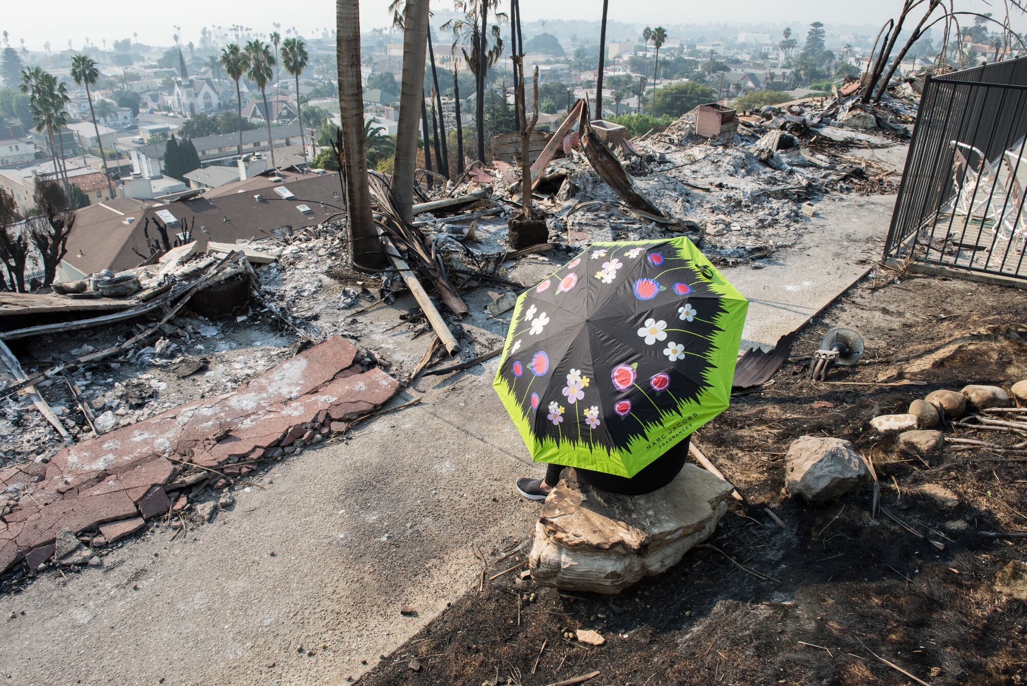 Peggy Breese, a resident of a 52-unit apartment complex takes a break from her search for belongings, Dec. 13, 2017, after the Thomas Fire roared through her neighborhood. Staff Sgt. Timothy Dawson, a C-130J Hercules aircraft maintenance technician with the 146th Airlift Wing, was also a resident of the apartment complex. The 146 Airlift Wing was activated Dec.5, 2017, to support CAL FIRE with wildfire suppression efforts within the state. (U.S. Air Force photo/Master Sgt. Brian Ferguson)