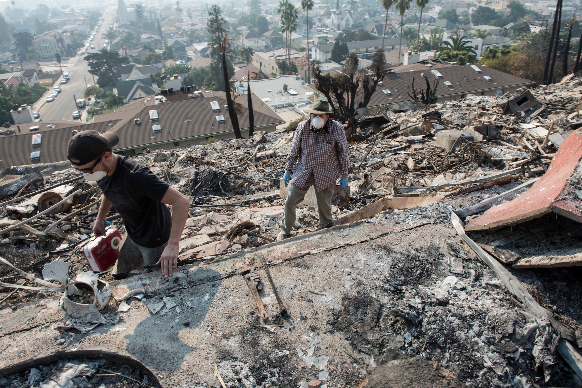 Residents of a 52-unit apartment complex search for belongings, Dec. 13, 2017, after the Thomas Fire roared through their neighborhood. Staff Sgt. Timothy Dawson, a C-130J Hercules aircraft maintenance technician with the 146th Airlift Wing, was also a resident of the apartment complex. The 146 Airlift Wing was activated Dec.5, 2017, to support CAL FIRE with wildfire suppression efforts within the state. (U.S. Air Force photo/Master Sgt. Brian Ferguson)