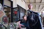 Airman prepare to load a commercial aircraft.