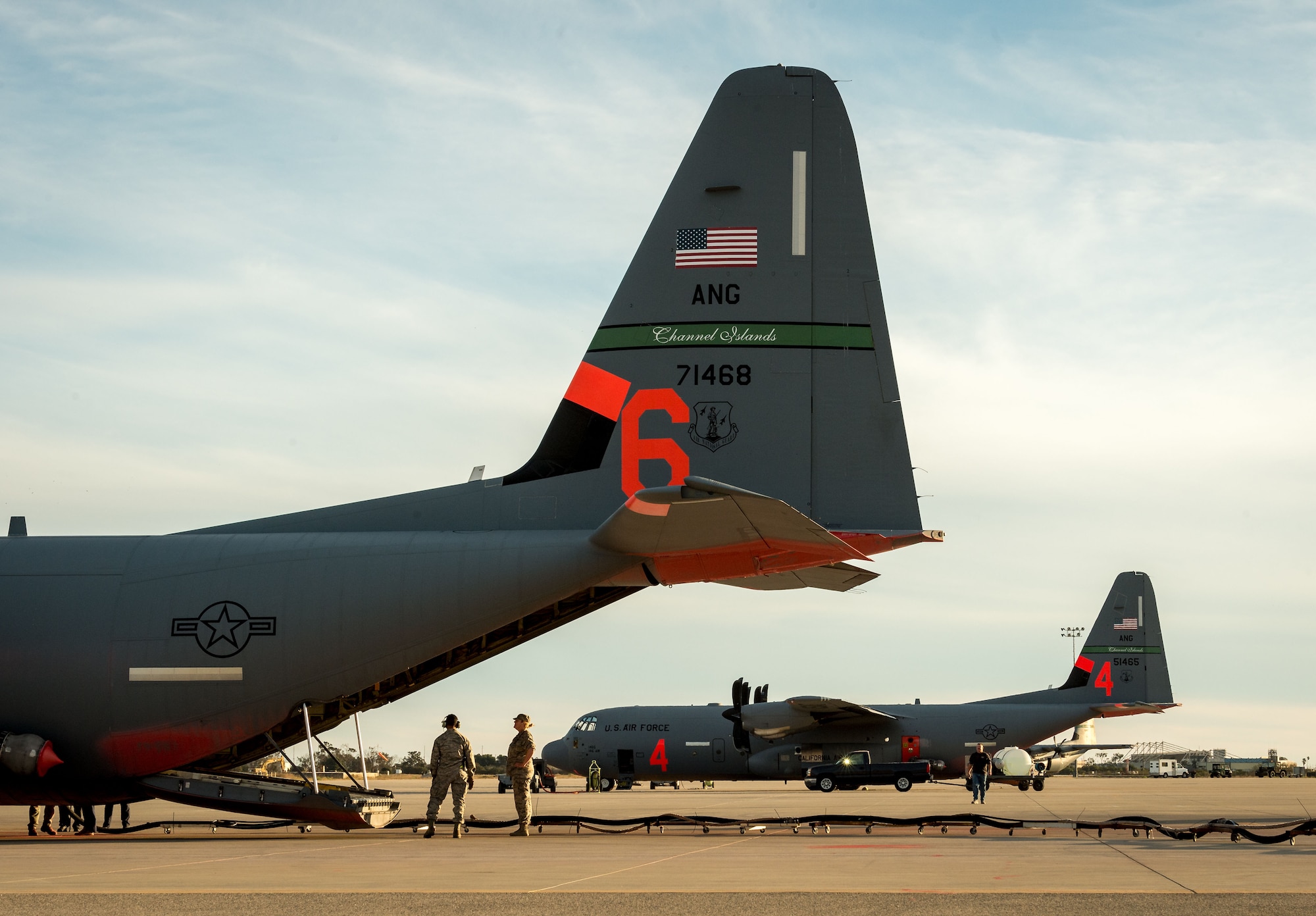 Two C-130Js of the 146th Airlift Wing, which carry the Modular Airborne Fire Fighting System, are reloaded with flame retardant chemicals at Channel Islands Air National Guard Base in Port Hueneme, California, in preparation for operations to contain the Thomas wildfire burning in Ventura and Santa Barbara Counties, Dec. 9, 2017. (U.S. Air Force photo by J.M. Eddins Jr.)