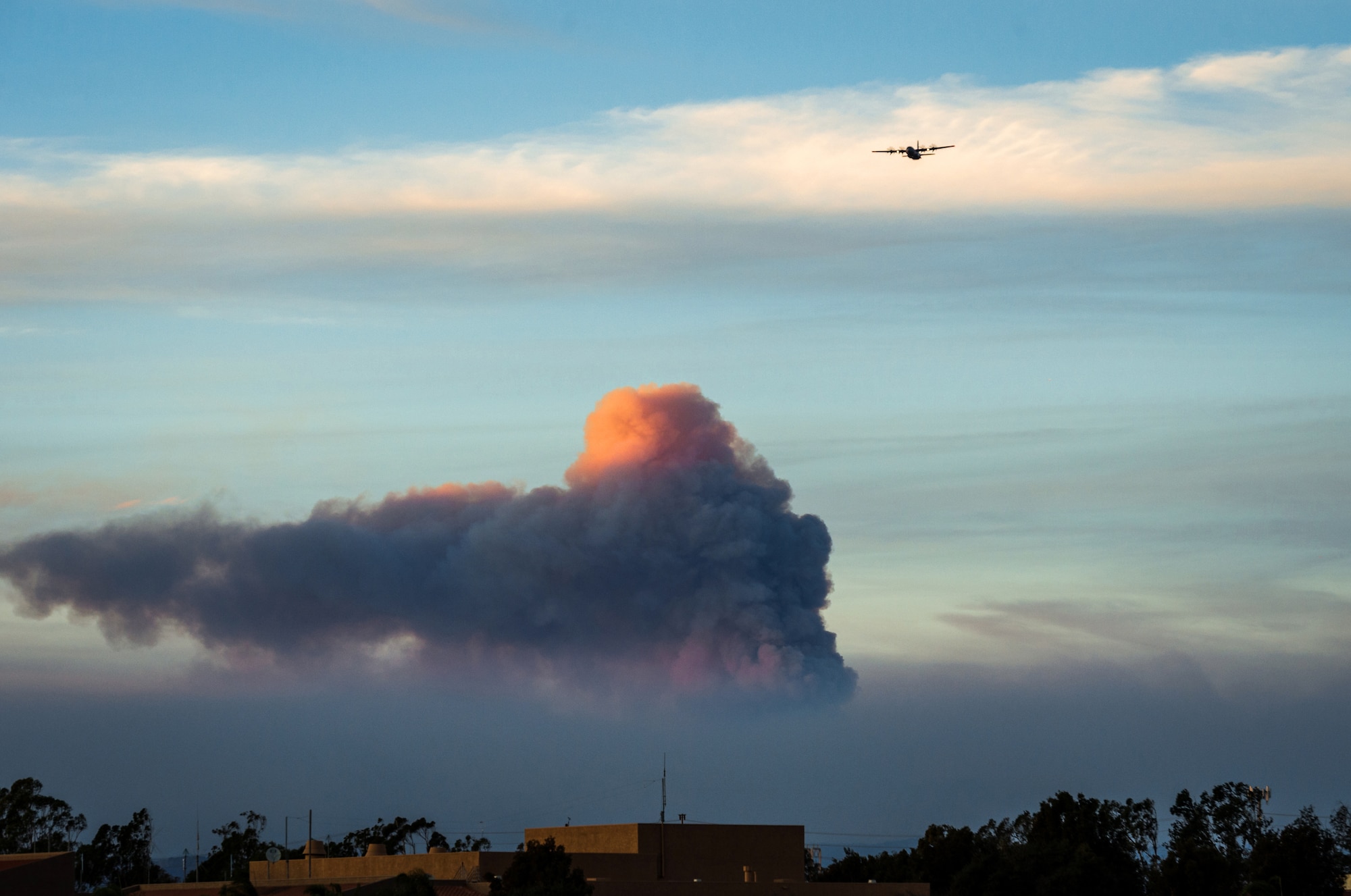 A C-130J of the 146th Airlift Wing, which carries the Modular Airborne Fire Fighting System (MAFFS), returns to Channel Islands Air National Guard Base in Port Hueneme, California, after dropping flame retardant chemicals on the Thomas Fire burning in Ventura and Santa Barbara Counties, Dec. 9, 2017. (U.S. Air Force photo by J.M. Eddins Jr.)