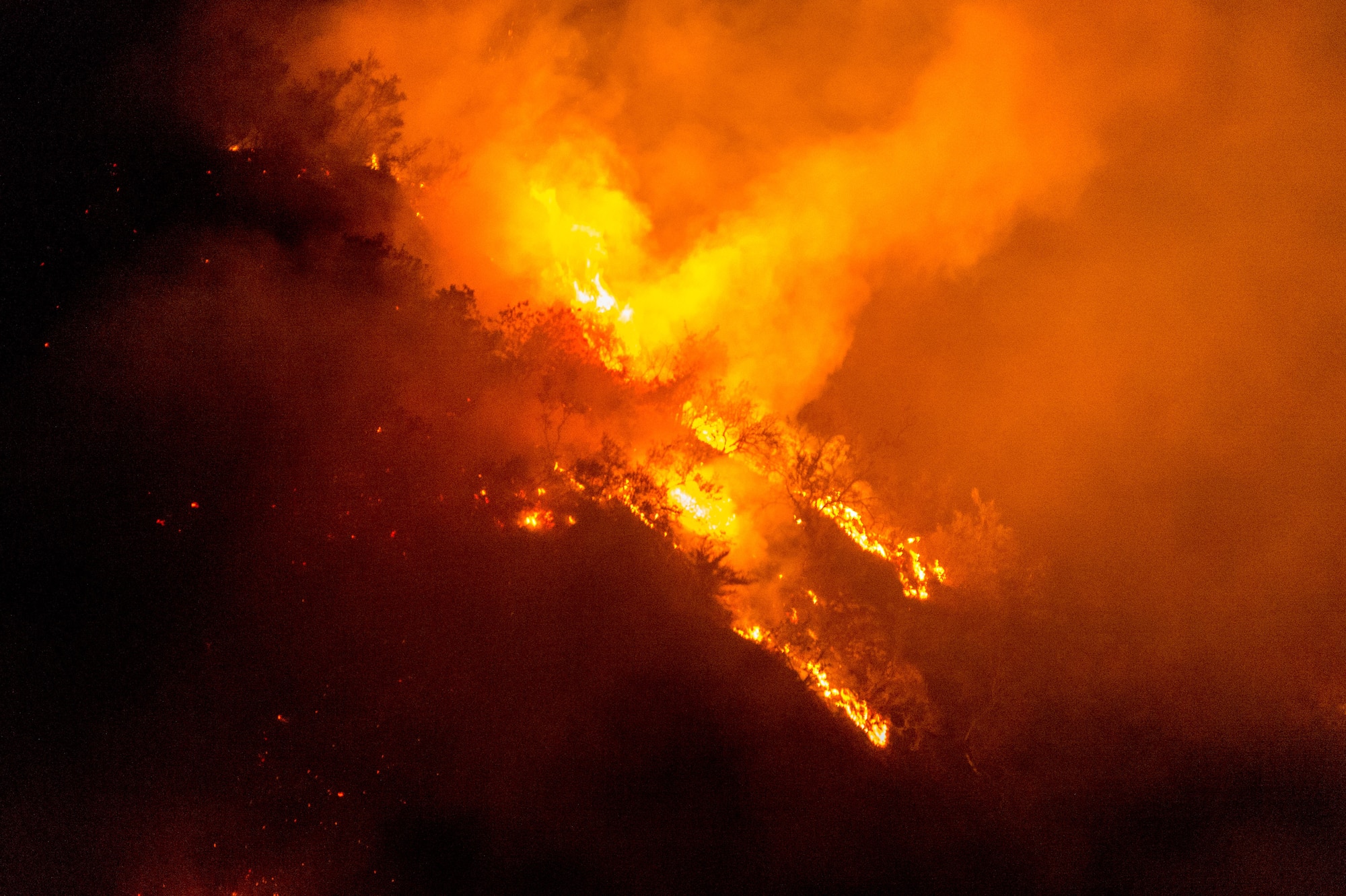 The Thomas Fire, named for the fire's point of origin near St. Thomas Aquinas College in Santa Paula, California, burns on a ridgeline in Santa Barbara County, Dec. 10, 2017. The fire, initially fanned by 80-mph Santa Ana winds, quickly spread across the Los Padres National Forest in Ventura and Santa Barbara counties. (U.S. Air Force photo by J.M. Eddins Jr.)