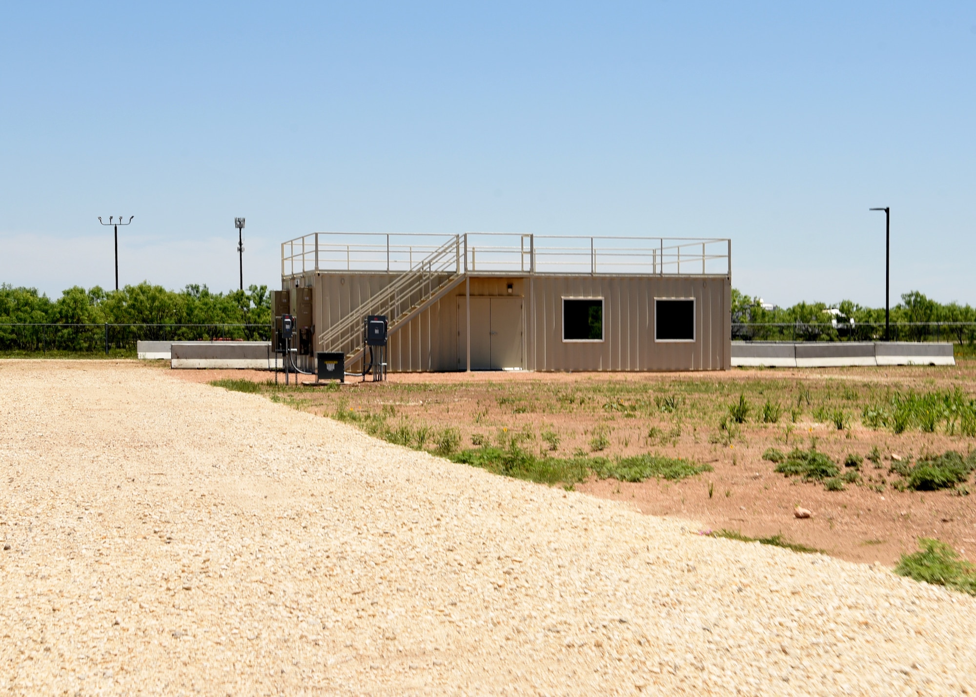 A new ground cover fire trainer building stands at the Louis F. Garland Department of Defense Fire Academy on Goodfellow Air Force Base, Texas, May 21, 2021. The trainer has a rehabilitation room inside for on-site training and added safety features to prevent heat related injuries while training. (U.S. Air Force photo by Senior Airman Abbey Rieves)