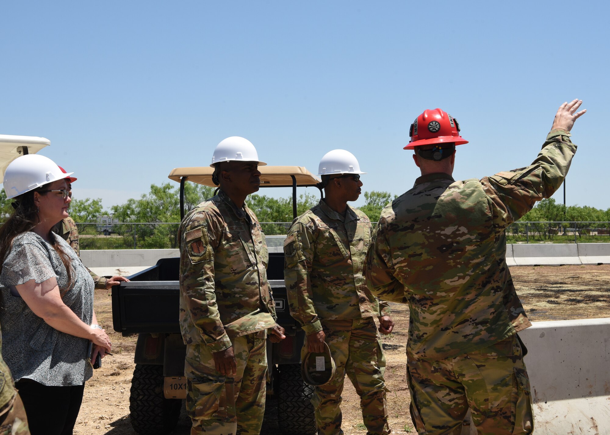 U.S. Air Force Tech. Sgt. Phillip Crews, 312th Training Squadron fire protection instructor, discusses a new ground cover fire trainer building at the Louis F. Garland Department of Defense Fire Academy on Goodfellow Air Force Base, Texas, May 21, 2021. The new facilities modernized the training environment by creating more realistic scenarios and providing extra safety measures. (U.S. Air Force photo by Senior Airman Abbey Rieves)