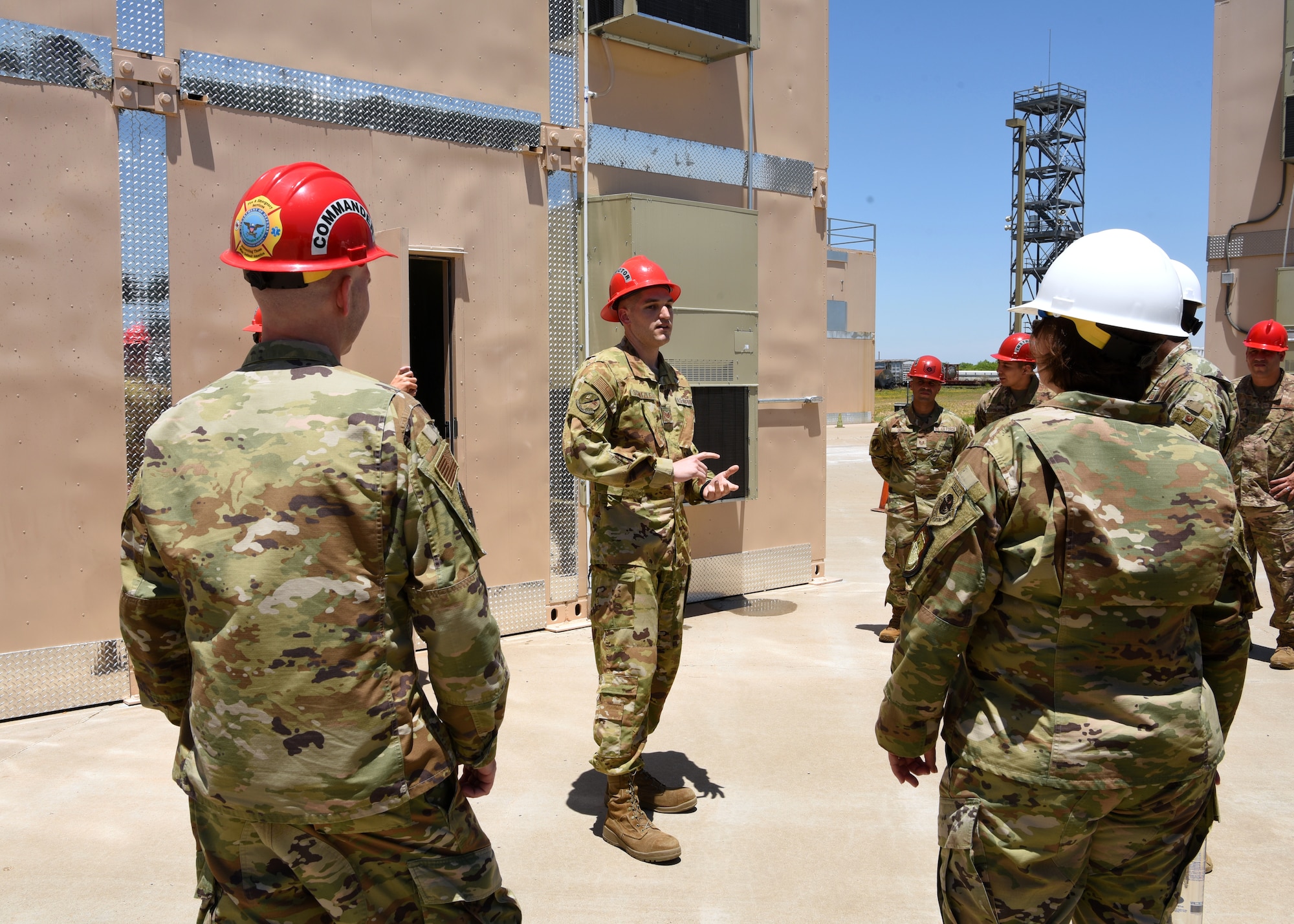 U.S. Air Force Tech. Sgt. Charles Schatzle, 312th Training Squadron basic course fundamentals fire protection instructor, briefs leadership on the features of a new training facility at the Louis F. Garland Department of Defense Fire Academy on Goodfellow Air Force Base, Texas, May 21, 2021. The new trainers incorporate more modern technology to better accomplish the mission. (U.S. Air Force photo by Senior Airman Abbey Rieves)