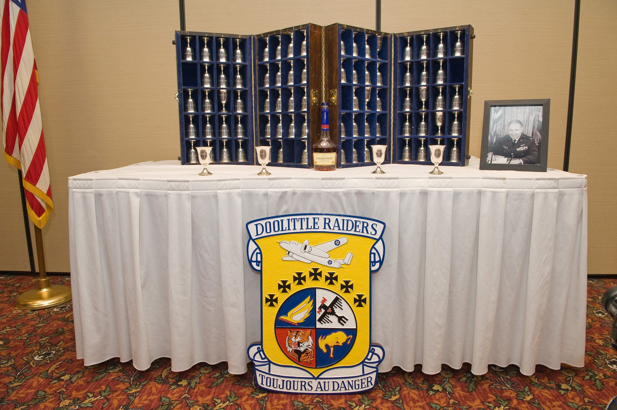 Goblets for Doolittle Raiders (left-right) Master Sgt. David J. Thatcher, Lt. Col. Richard E. Cole, Major Thomas Griffin, and Lt. Col. Robert L. Hite stand charged and ready for the Goblet Ceremony on April 16, 2010 in Fairborn, Ohio.  the ceremony honors all who participated in the Doolittle Raid on Tokyo during W.W. II. The upright goblets represent aircrew who have survived to this day.  During the ceremony the name of every person was read and a Doolittle Raider responds to indicate the spirit of those who passed are present.  The collection of goblets, each with an aircrew name engraved both right side up and upside down.  The set of goblets is now maintained by the National Museum of the U.S. Air Force.  (U.S. Air Force photo/Lance Cheung)