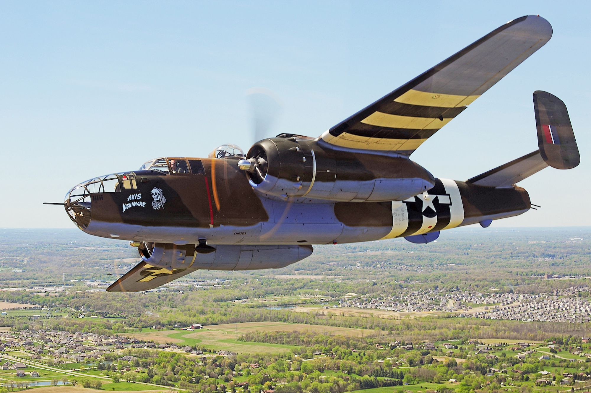 A vintage B-25 Mitchell "Axis Nightmare" flies by the National Museum of the U.S. Air Force at Wright-Patterson Air Force Base, Ohio, April 18, 2010. The flight was in honor of the Doolittle Raiders attack on Tokyo April 18, 1942. (U.S. Air Force photo/Tech. Sgt. Jacob N. Bailey)