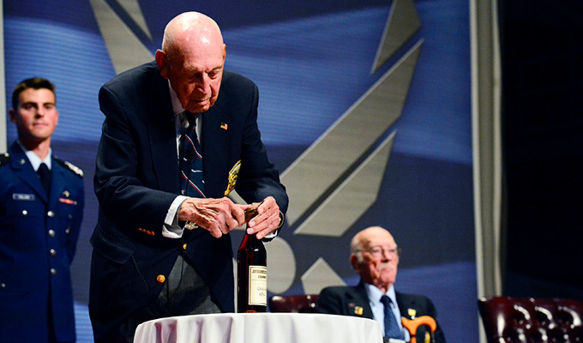 Retired Lt. Col. Richard “Dick” E. Cole opens the 1896 bottle of cognac before The Doolittle Tokyo Raiders shared their last and final toast at the National Museum of the U.S. Air Force Nov. 09, 2013 in Dayton, Ohio. Cole was the copilot of Aircraft No. 1. (U.S. Air Force photo/Desiree N. Palacios)