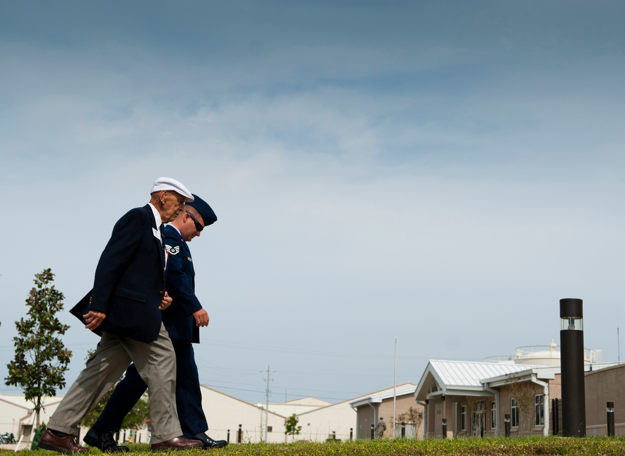 Retired Lt. Col. Dick Cole is escorted into a ceremony where a air plane hangar was dedicated to a fellow Doolittle Raider, retired Lt. Col. Ed Saylor, April 17, 2013, on Eglin Air Force Base, Fla. (U.S. Air Force photo by Staff Sgt. David Salanitri)