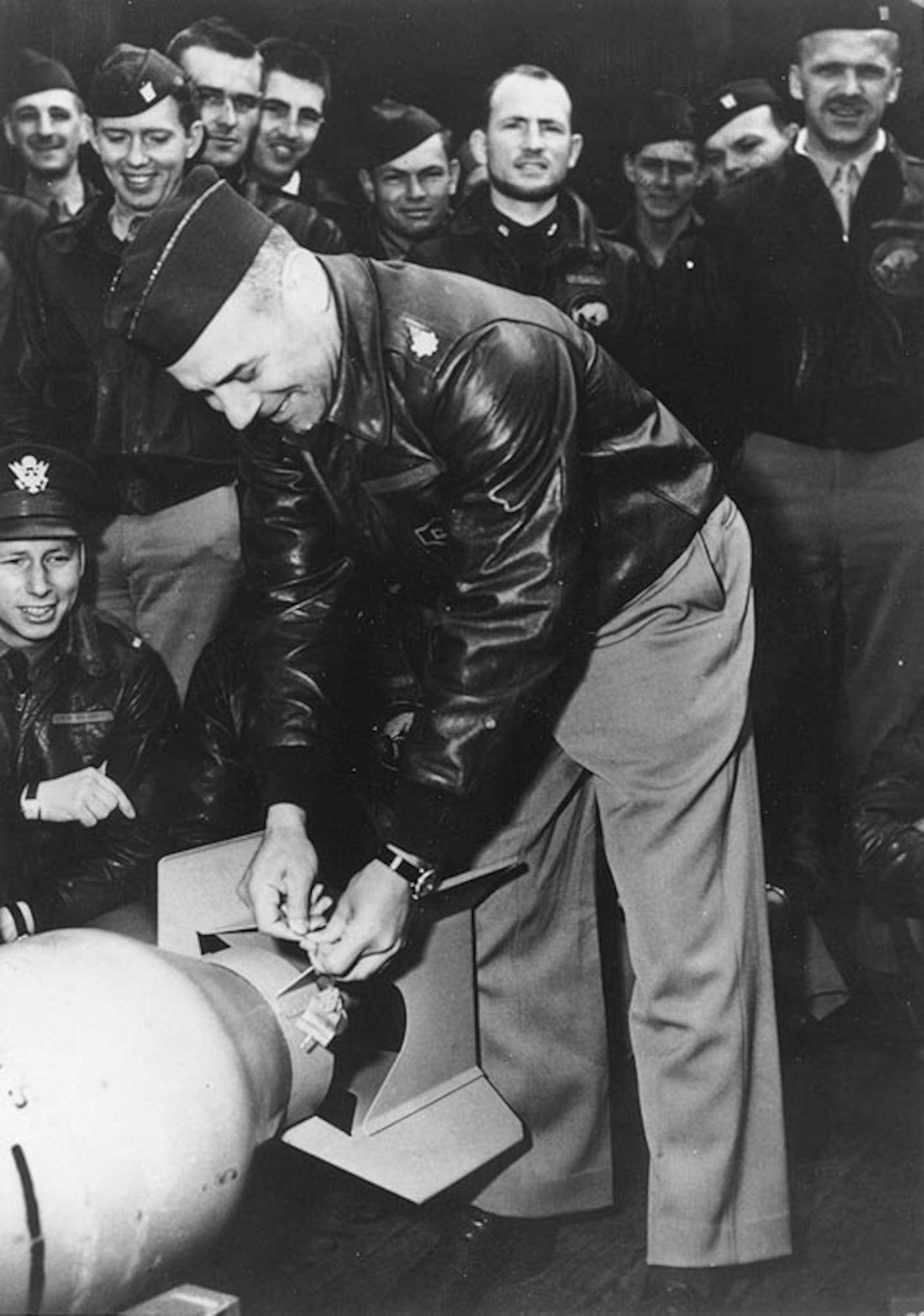 Lieutenant Colonel Doolittle wires a Japanese "Friendship Medal" to a bomb, for "return" to its originators during the "Doolittle Raid" on Japan five months after the Japanese attack on Pearl Harbor..