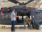 Chief Master Sgt. Michael Morgan sits in a helicopter at the IAAFA hangar May 10, 2021.