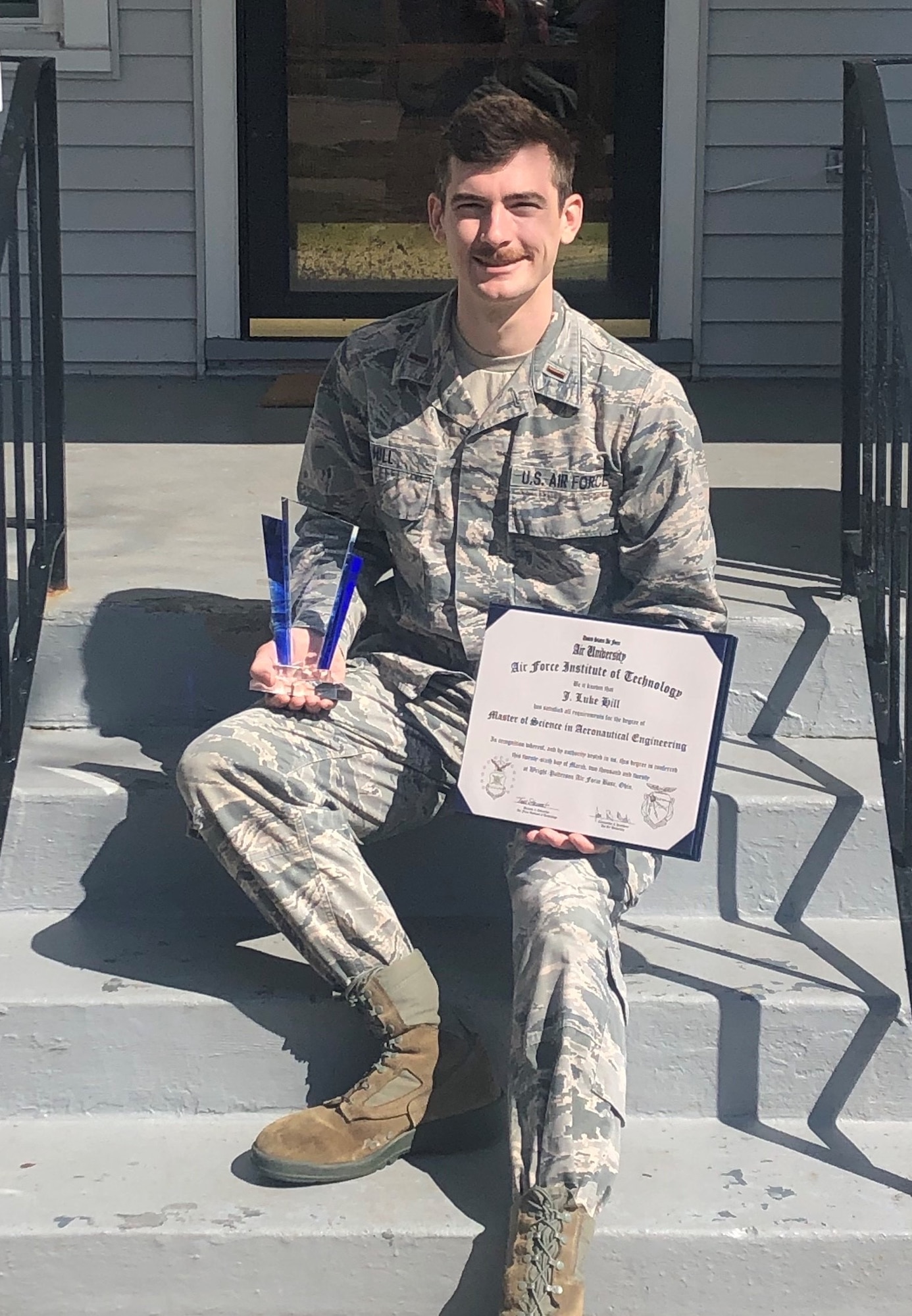 1st Lt. Jonathan “Luke” Hill, a researcher with AFRL, poses with his Dean's List certificate he earned while attending the Air Force Institute of Technology at Wright-Patterson Air Force Base, Ohio. (Courtesy photo)