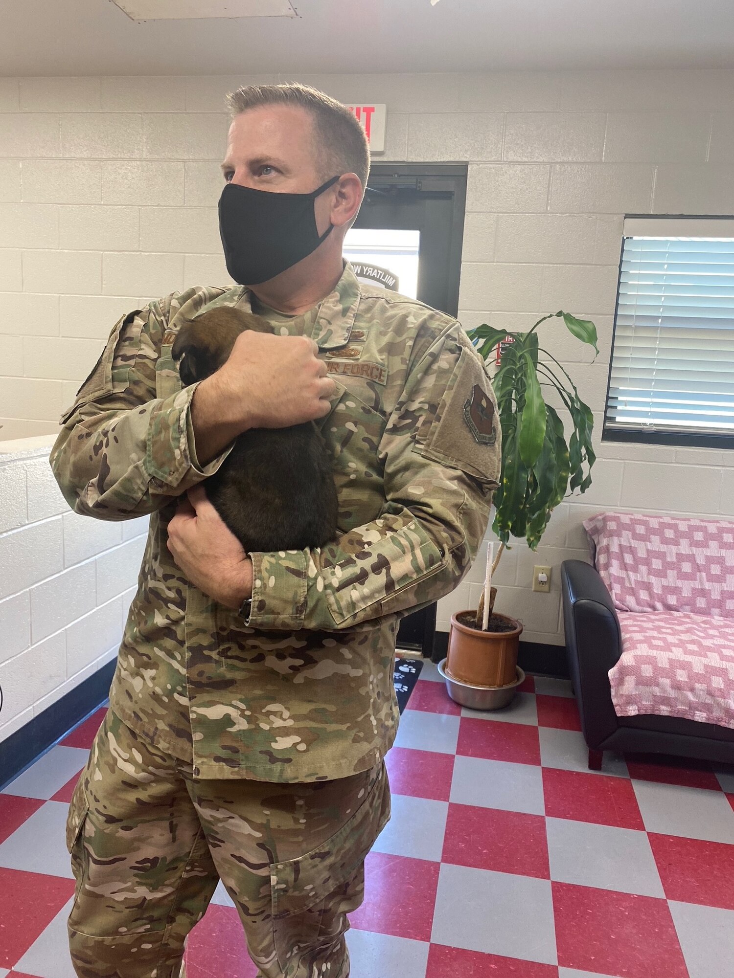Chief Morgan holds a puppy at the 341st TRS.