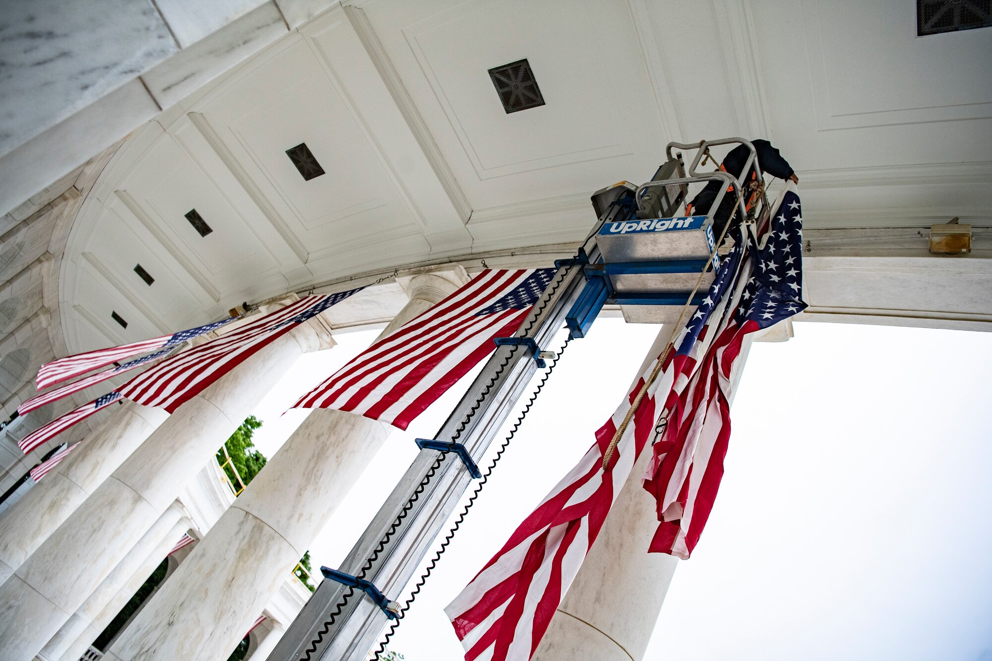 Employees hang U.S. flags.