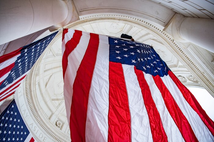 An American flag hangs in a building.