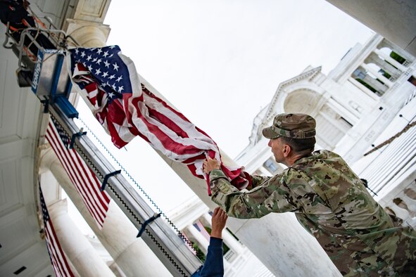 Employees hang U.S. flags.