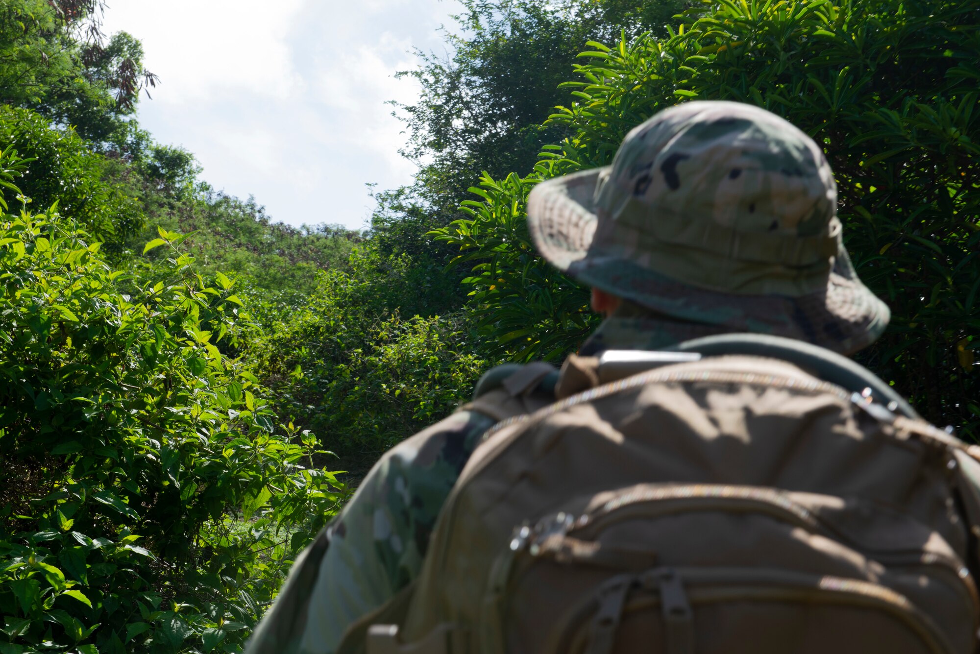 Tech. Sgt. Adam Rogers assigned to the 36th Security Forces Squadron performs a ground tasking operation overlooking a cliff face searching for signs of human activity along the eastern shoreline on Andersen Air Force Base, Guam May 14 2021. Andersen Air Force Base covers 14,600 acres, more than half of which is undeveloped land. (U.S. Air Force photo by SSgt Nicholas Crisp)