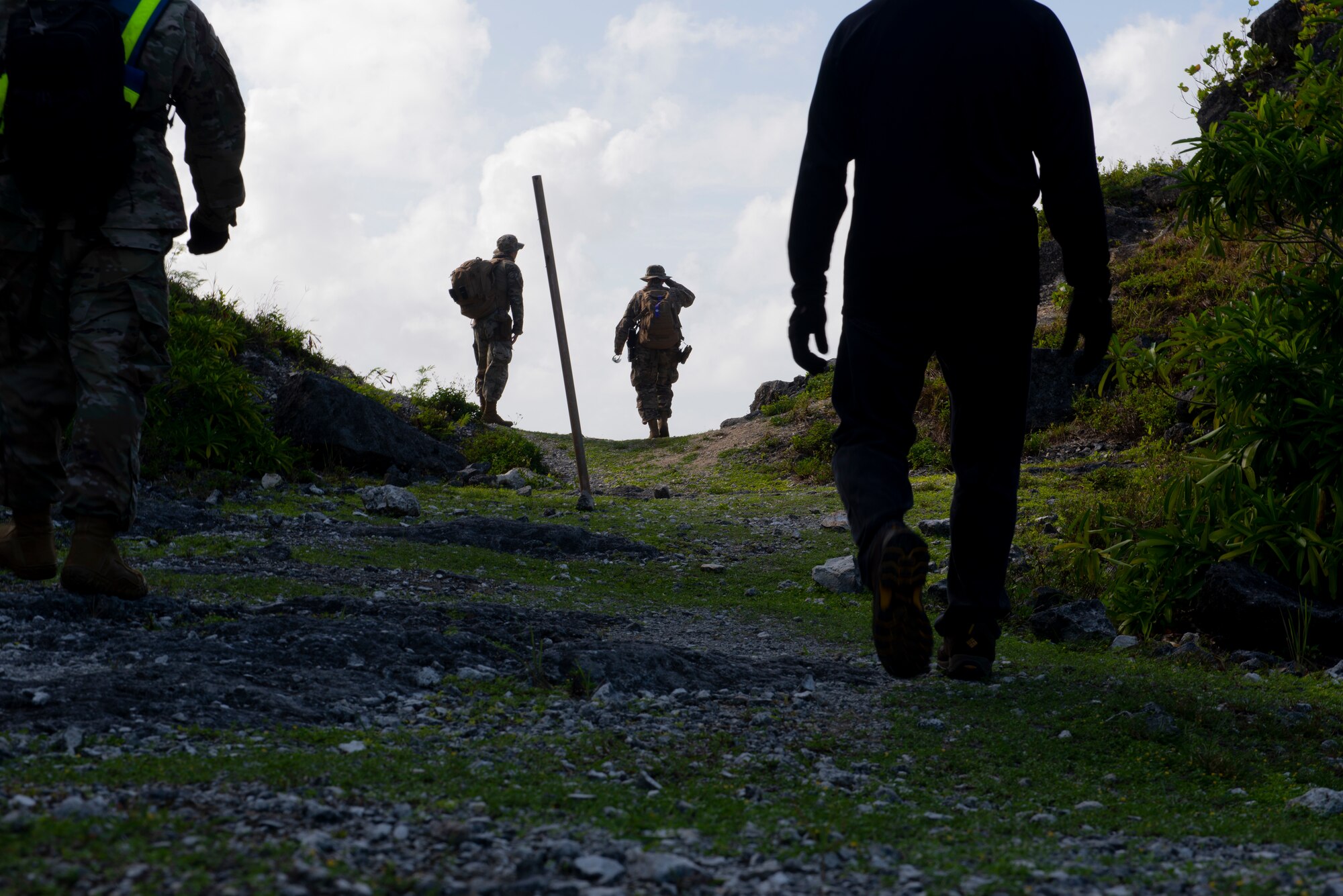 Tech. Sgt. Adam Rogers assigned to the 36th Security Forces Squadron performs a ground tasking operation overlooking a cliff face searching for signs of human activity along the eastern shoreline on Andersen Air Force Base, Guam May 14 2021. Andersen Air Force Base covers 14,600 acres, more than half of which is undeveloped land. (U.S. Air Force photo by SSgt Nicholas Crisp)