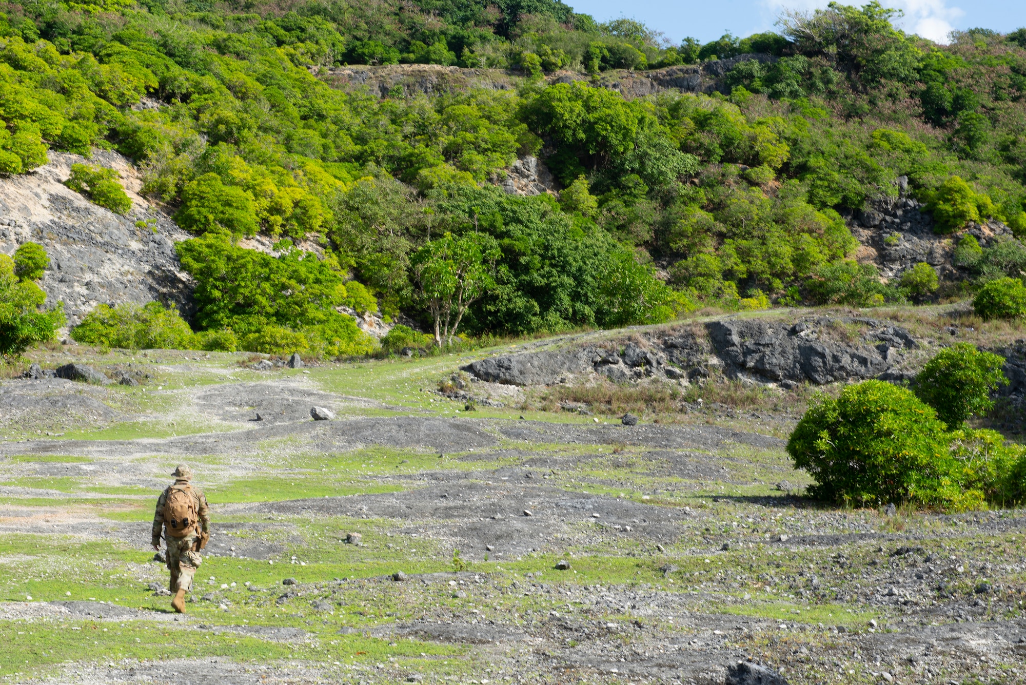 Tech. Sgt. Adam Rogers assigned to the 36th Security Forces Squadron performs a ground tasking operation overlooking a cliff face searching for signs of human activity along the eastern shoreline on Andersen Air Force Base, Guam May 14 2021. Andersen Air Force Base covers 14,600 acres, more than half of which is undeveloped land. (U.S. Air Force photo by SSgt Nicholas Crisp)