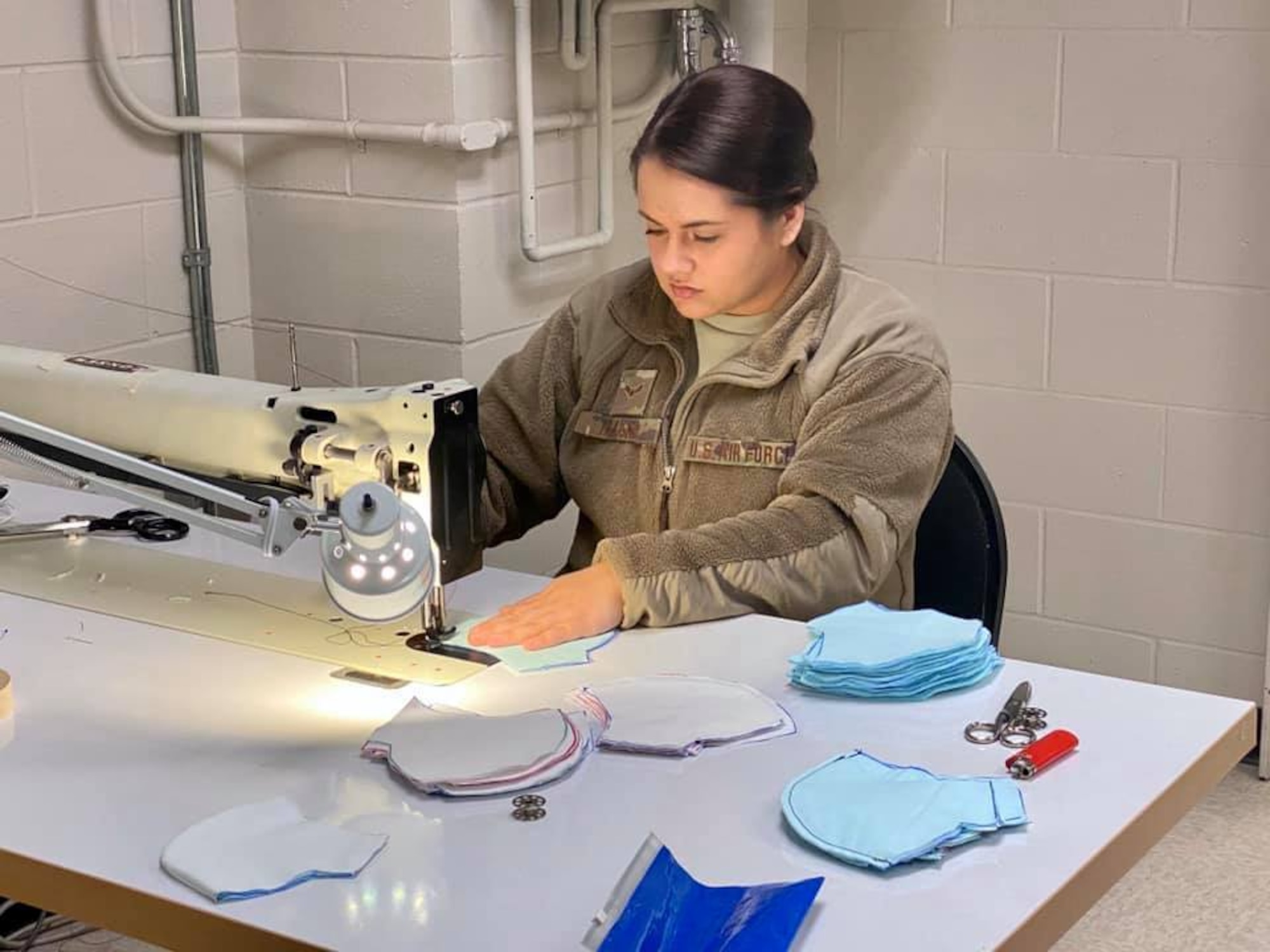An Aircrew Flight Equipment specialist from the Duluth-based 148th Fighter Wing, Minnesota Air National Guard sews protective masks for mission essential military personnel.  Airmen from various work groups from the wing are cutting fabric, laundering masks and disseminating the completed masks.  Airmen are utilizing innovative ways to slow the spread of COVID-19.