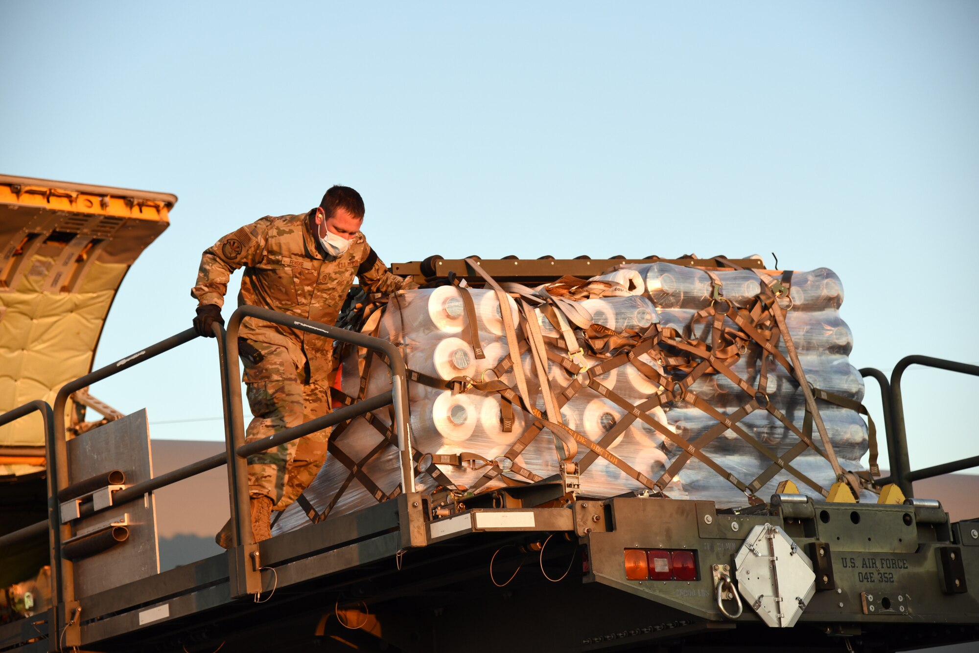 161st Air Refueling Wing service members unload material from a KC-135 Stratotanker to be used to make protective gowns for statewide use April 9, 2020 at Goldwater Air National Guard Base, Phoenix. The delivery is part of the Arizona National Guard’s response to community needs during this state of emergency (U.S. Air National Guard photo by Tech. Sgt. Michael Matkin).