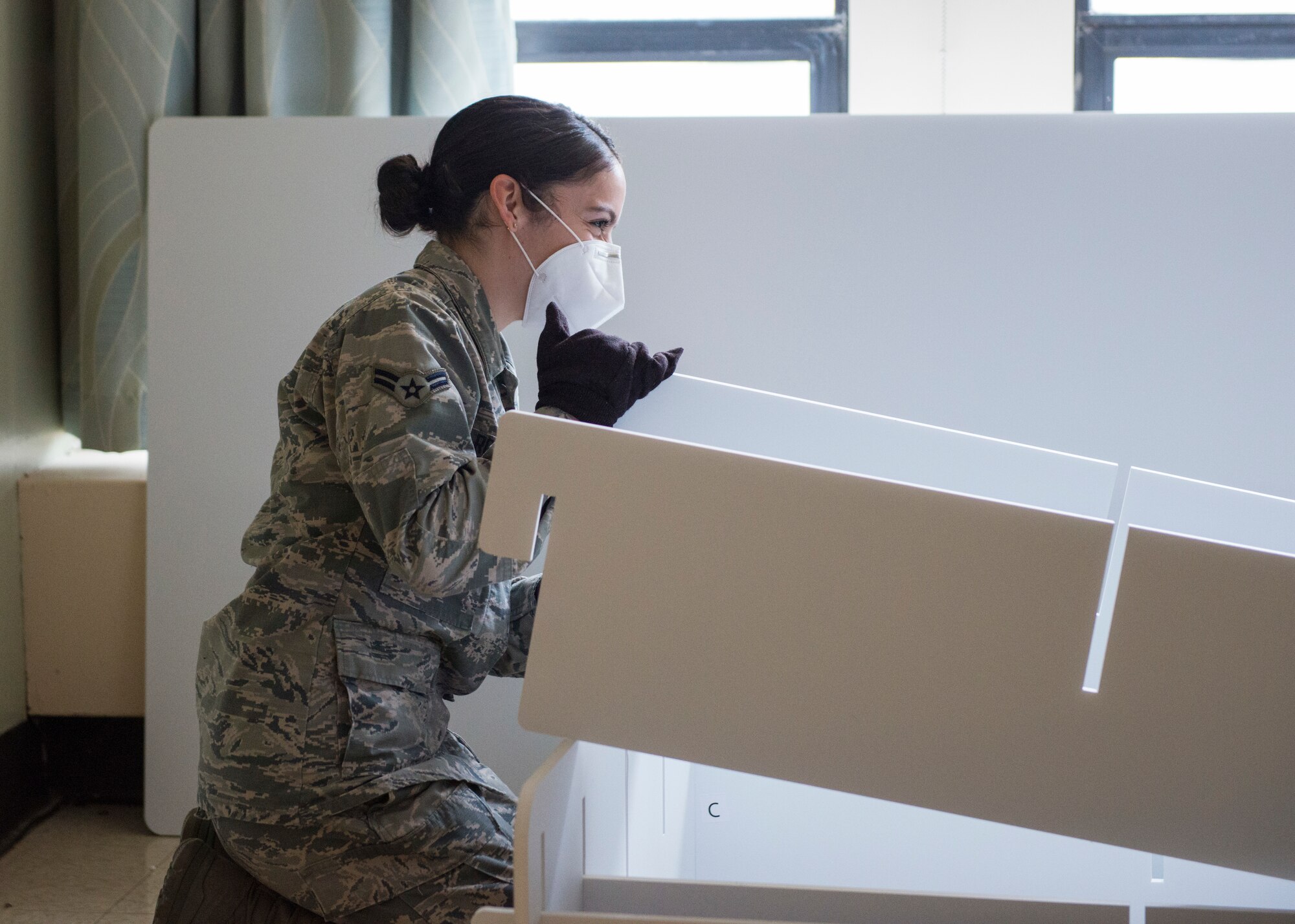 Airman 1st Class Arielle Robles, 103rd Maintenance Group administration specialist, helps construct a bed frame at Stamford Hospital in Stamford, Connecticut, April 8, 2020. Connecticut National Guard Soldiers and Airmen set up 200 beds at the hospital to build capacity and constructed Alaskan Small Shelter System tents for a separate triage area in response to the COVID-19 pandemic. (U.S. Air National Guard photo by Staff Sgt. Steven Tucker)