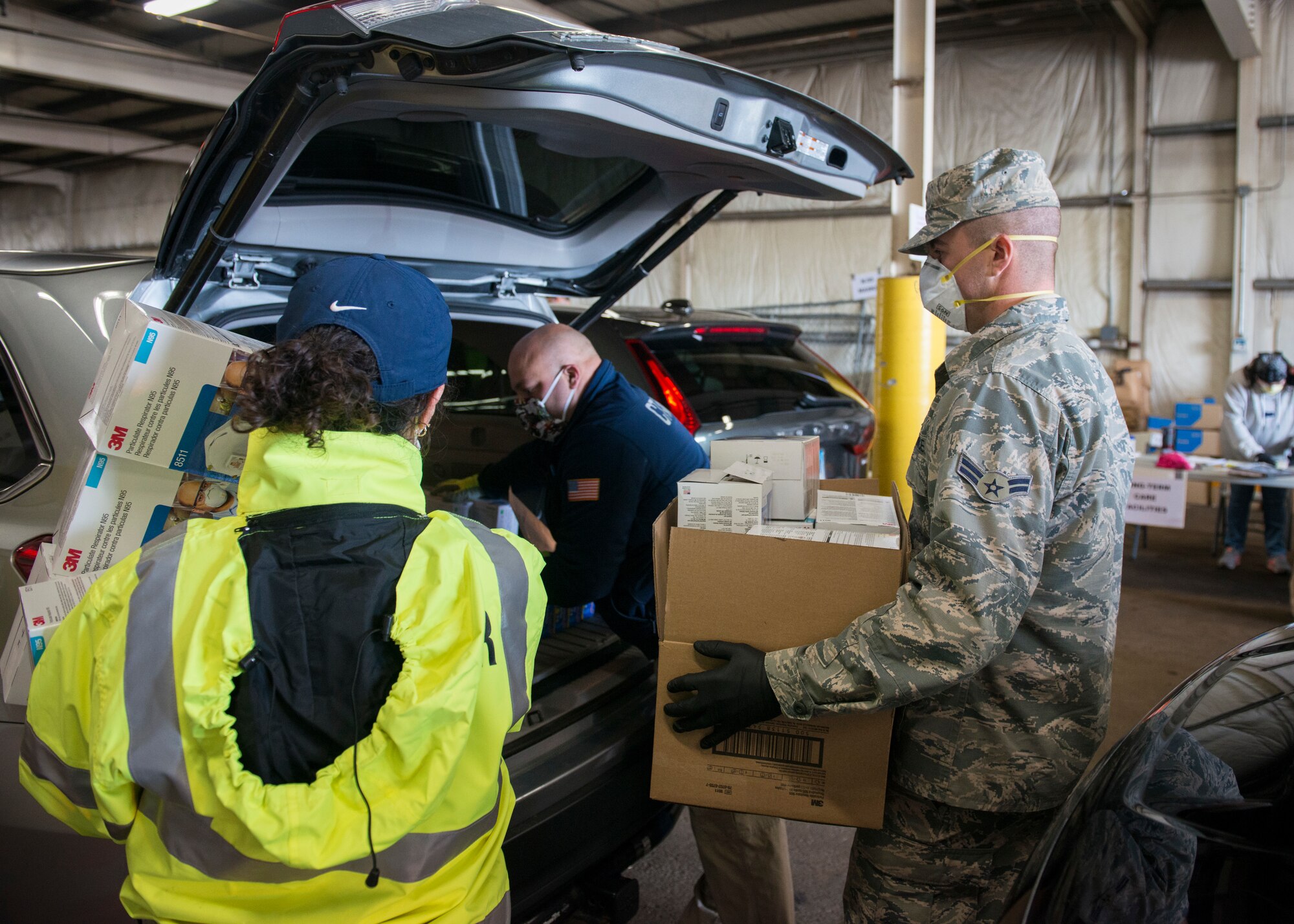 A Connecticut National Guard Airman helps load boxes of PPE into a vehicle at a distribution site in West Hartford, Connecticut, April 22, 2020. The Connecticut National Guard is supporting the Connecticut Department of Public Health in distributing items including masks, gloves, and face shields to assisted living facilities, residential care homes, long-term care facilities, and first responders. (U.S. Air National Guard photo by Staff Sgt. Steven Tucker)
