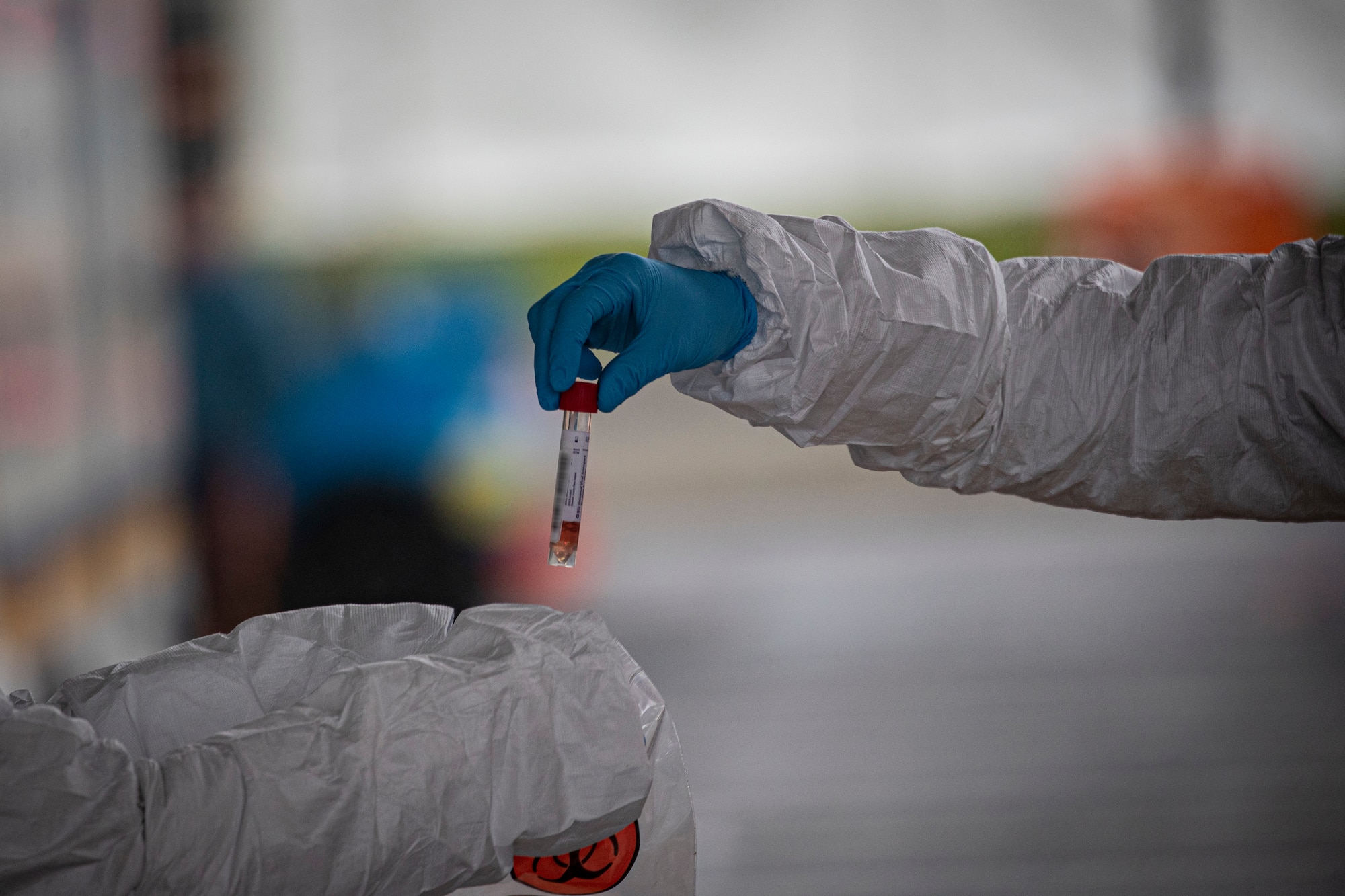 Medical staff collect samples from a patient at a COVID-19 Community-Based Testing Site at the PNC Bank Arts Center in Holmdel, N.J., March 23, 2020.  The testing site, established in partnership with the Federal Emergency Management Agency, is staffed by the New Jersey Department of Health, the New Jersey State Police, and the New Jersey National Guard. This image has been altered to protect personal information. (U.S. Air National Guard photo by Master Sgt. Matt Hecht)