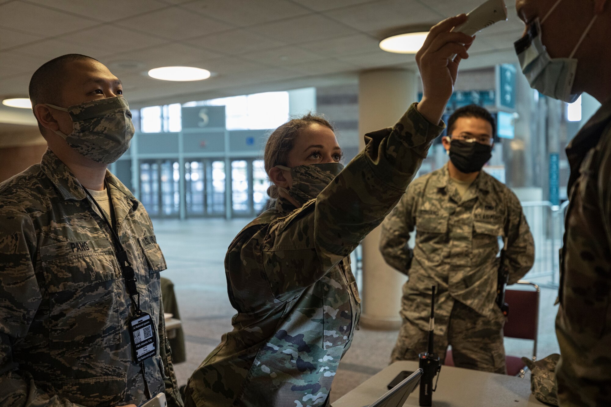 U.S. Air Force Airmen with the New Jersey Air National Guard’s 177th Fighter Wing screen Soldiers entering the Federal Medical Station at the Atlantic City Convention Center in Atlantic City, N.J., April 18, 2020. (U.S. Air National Guard photo by Master Sgt. Matt Hecht)