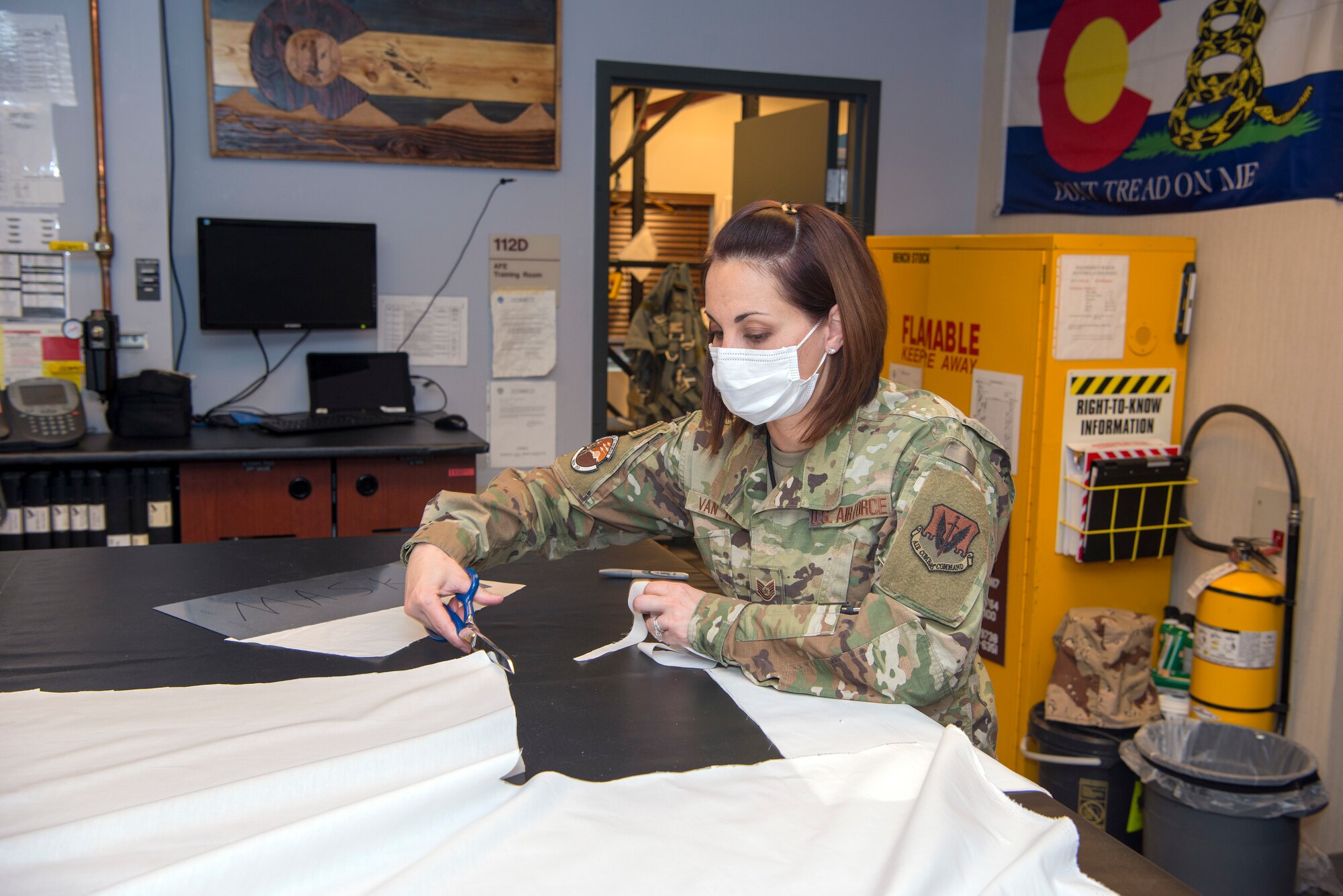 U.S. Air National Guard Tech. Sgt. Jennifer Van Note, an aircrew flight equipment specialist, is creating some of the 500 masks that have been requested by the commander of the 140th Wing, in order to decrease the chances of the COVID-19 spread while guard members have to be in close proximity of one another due to job constraints while performing vital mission operations at Buckley Air Force Base, Aurora, Colo., April 10, 2020. Members of the Colorado National Guard volunteer to support state and local officials combat the Corona Virus Pandemic by assisting multiple agencies in the state of Colorado. (U.S. Air National Guard photo by Senior Master Sgt. John Rohrer)