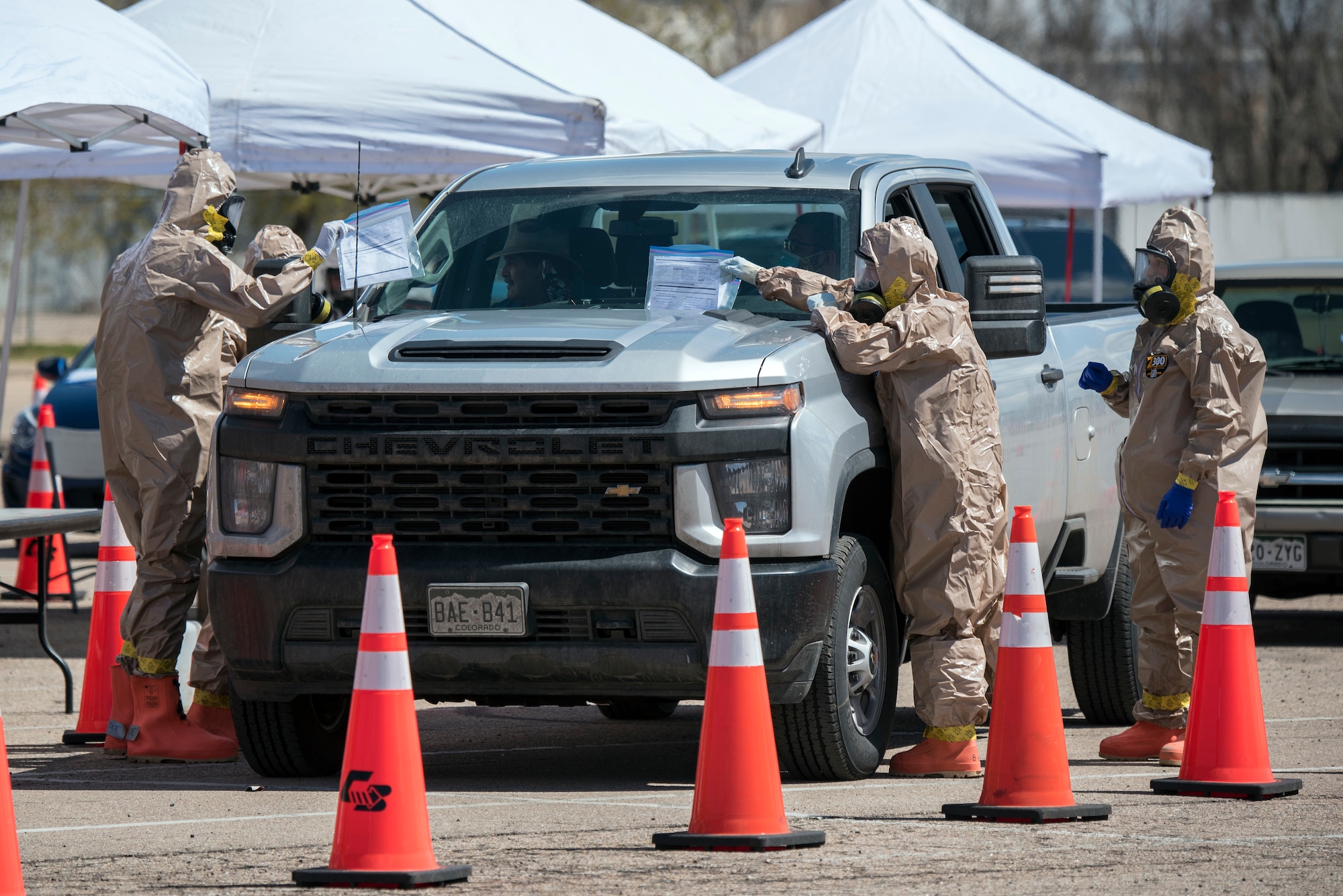 Colorado National Guard members conduct COVID-19 testing at a drive up testing site in Greeley, Colorado, April 23, 2020.  Nearly 70 Colorado National Guard members from the Chemical, Biological, Radiological, Nuclear and high-yiald (CBRNE) Enhanced Response Force Package (CERFP) tested residents in the Greeley area. (U.S. Air National Guard photo by Senior Master Sgt. John Rohrer)