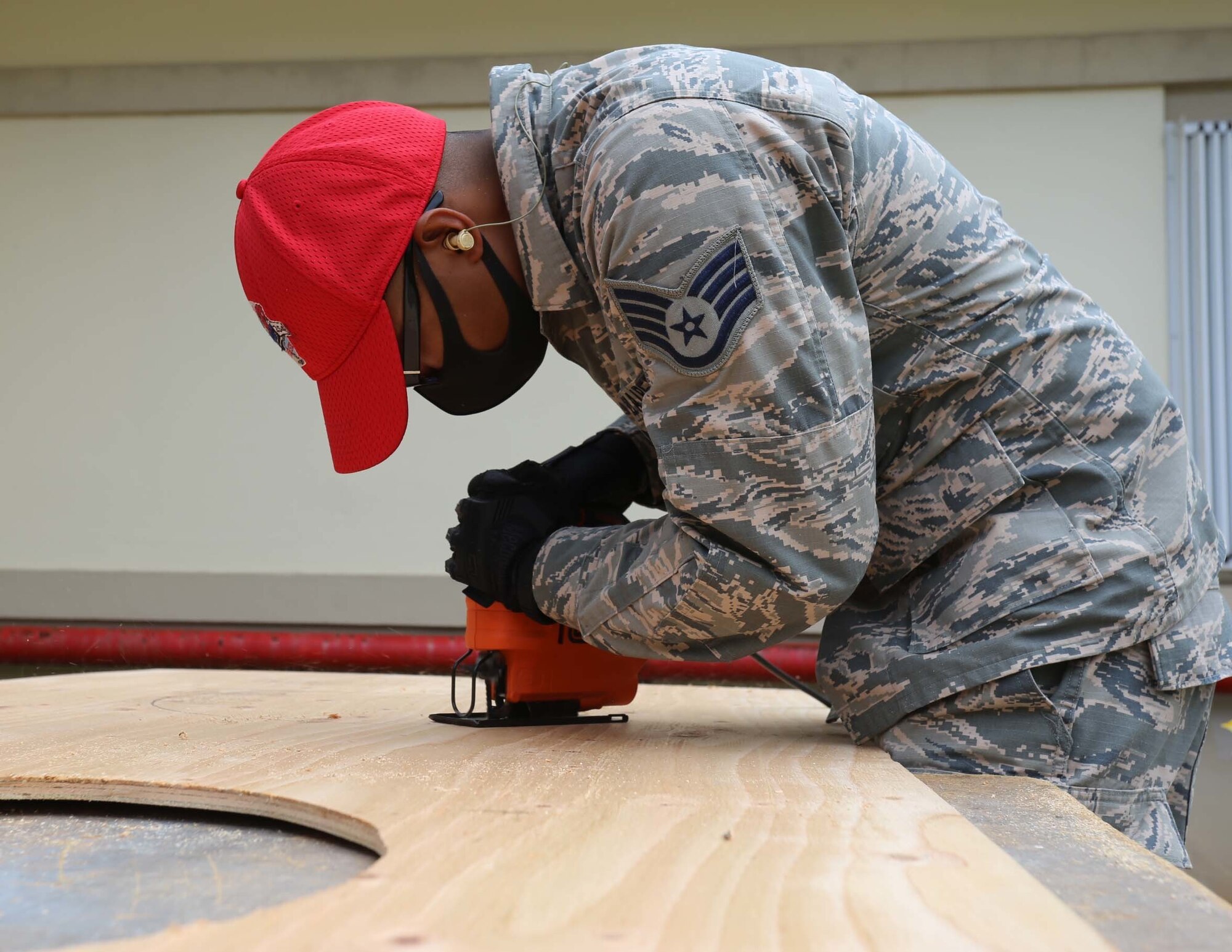 BARRIGADA, Guam (April 20, 2020) – Staff Sgt. Jude Santos, 254th REDHORSE Squadron, Guam Air National Guard, cuts plywood for an environmental control unit installation at the Skilled Nursing Facility in Barrigada April 20. The Guam National Guard continues to work with federal and local agencies during the island’s fight against COVID-19. (U.S. Army National Guard photo by JoAnna Delfin)