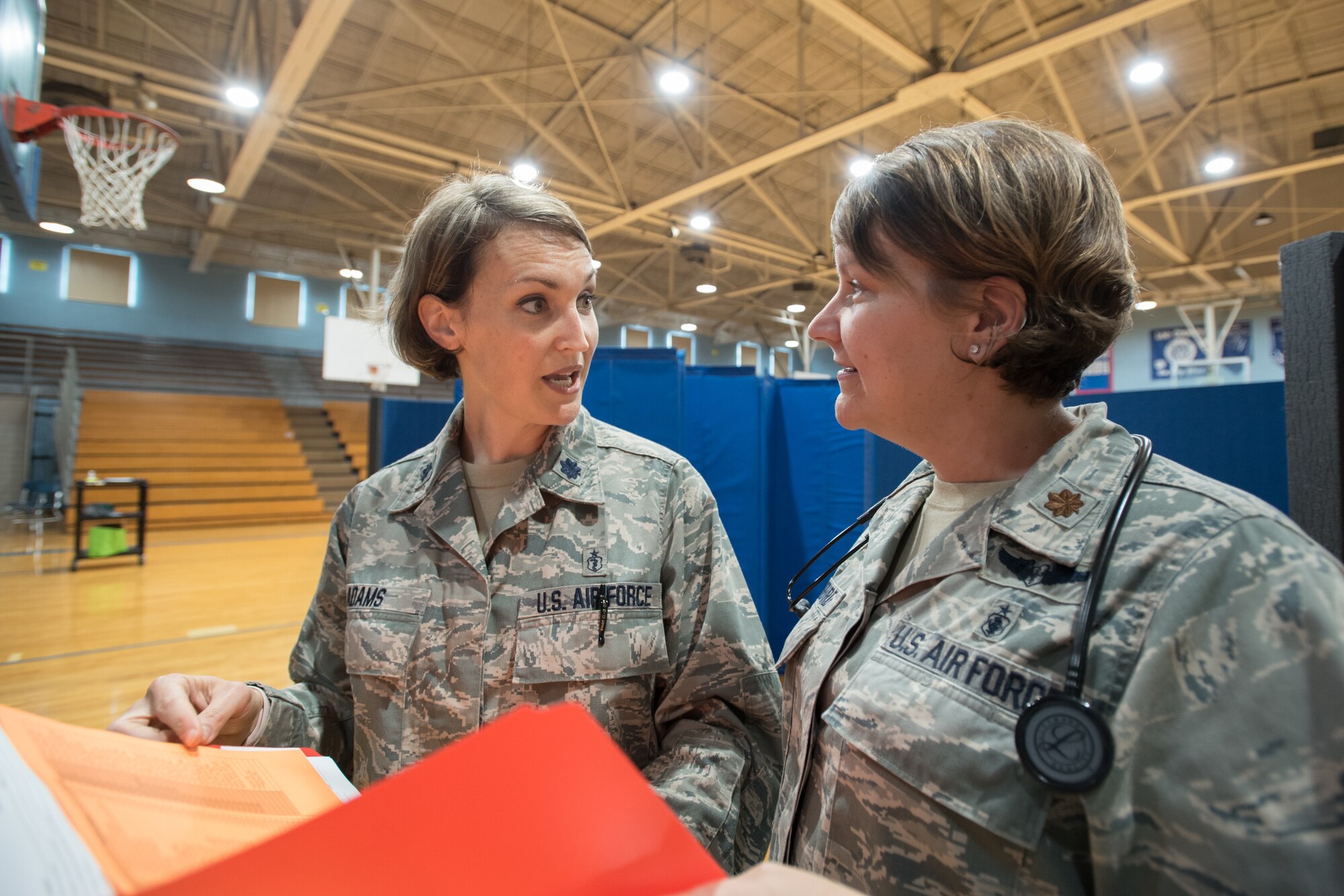 U.S. Air Force Lt. Col. Patricia Adams (left), an optometrist from the Kentucky Air National Guard’s 123rd Airlift Wing, discusses patient care with U.S. Air Force Maj. Tiffany Hubbard, a nurse practitioner, at a health-care clinic being run by the Air Guard and U.S. Navy Reserve at Lee County High School in Beattyville, Ky., June 20, 2018. The Beattyville clinic is one of four that comprised Operation Bobcat, a 10-day mission to provide military medical troops with crucial training in field operations and logistics while offering no-cost health care to the residents of Eastern Kentucky. The clinics, which operated from June 15-24, offered non-emergent medical care; sports physicals; dental cleanings, fillings and extractions; eye exams and no-cost prescription eye glasses. (U.S. Air National Guard photo by Lt. Col. Dale Greer)