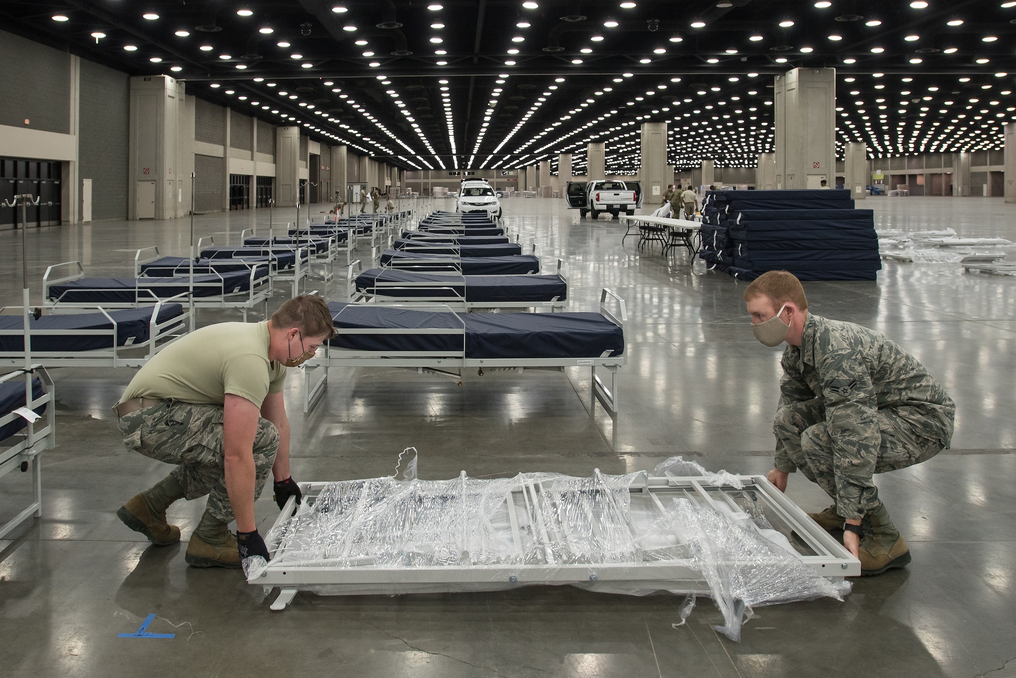 More than 30 members of the Kentucky Air National Guard’s 123rd Civil Engineer Squadron set up hospital beds and clinical space at the Kentucky Fair and Exposition Center in Louisville, Ky., April 13, 2020. The site, which is expected to be operational April 15, will serve as an Alternate Care Facility for patients suffering from COVID-19 if area hospitals exceed available capacity. The location initially can treat up to 288 patients and is scalable to 2,000 beds. (U.S. Air National Guard photo by Dale Greer)