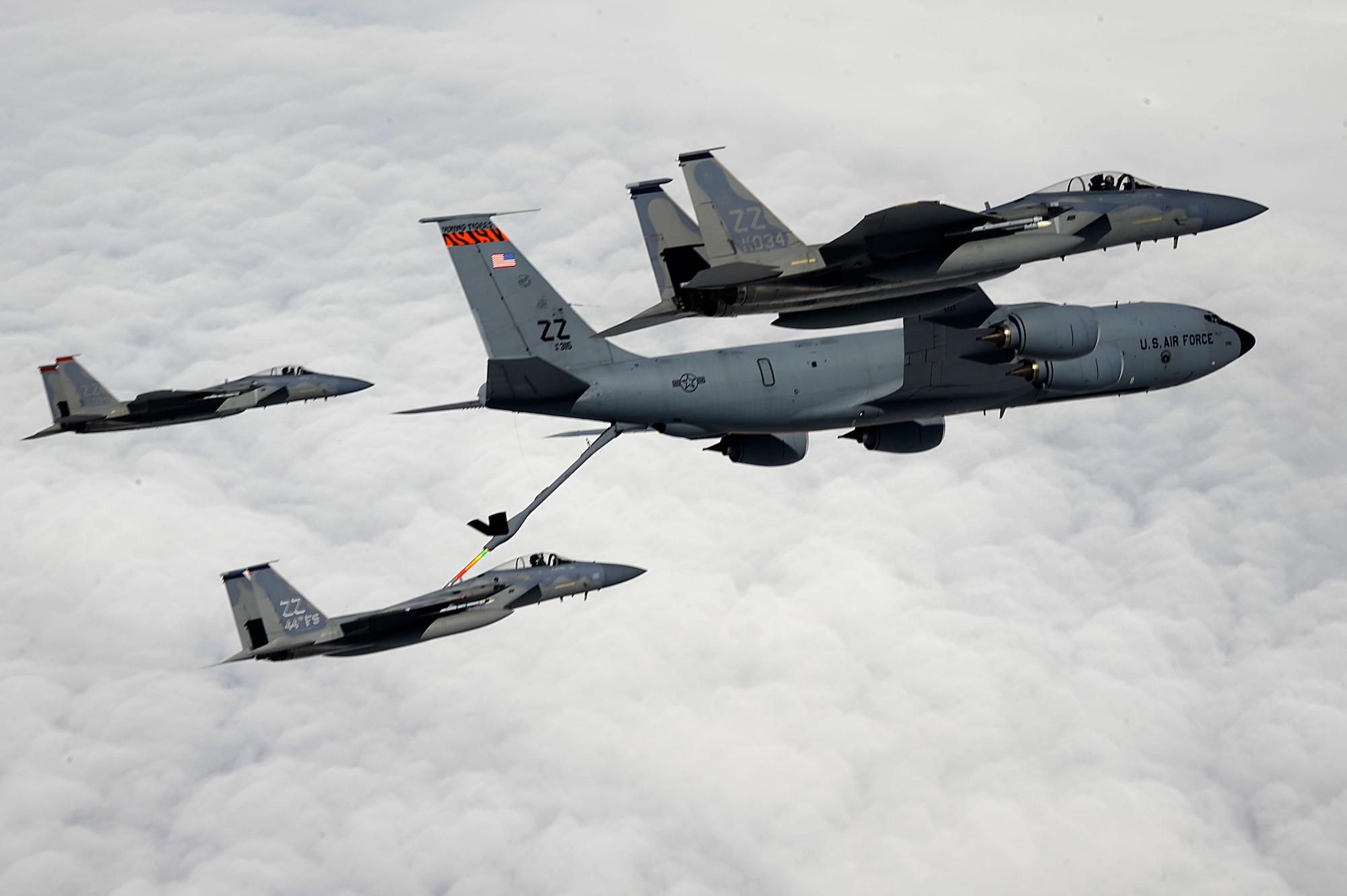 An U.S. Air Force KC-135 Stratotanker aerial refueling aircraft from the 909th Air Refueling Squadron refuels a 44th Fighter Squadron F-15 Eagle while two other F-15s fly in formation during a training mission over Okinawa, Japan, April 5, 2013. The KC-135 and F-15 are two of five aircraft regularly operated from Kadena Air Base. (U.S. Air Force photo/Senior Airman Maeson L. Elleman)