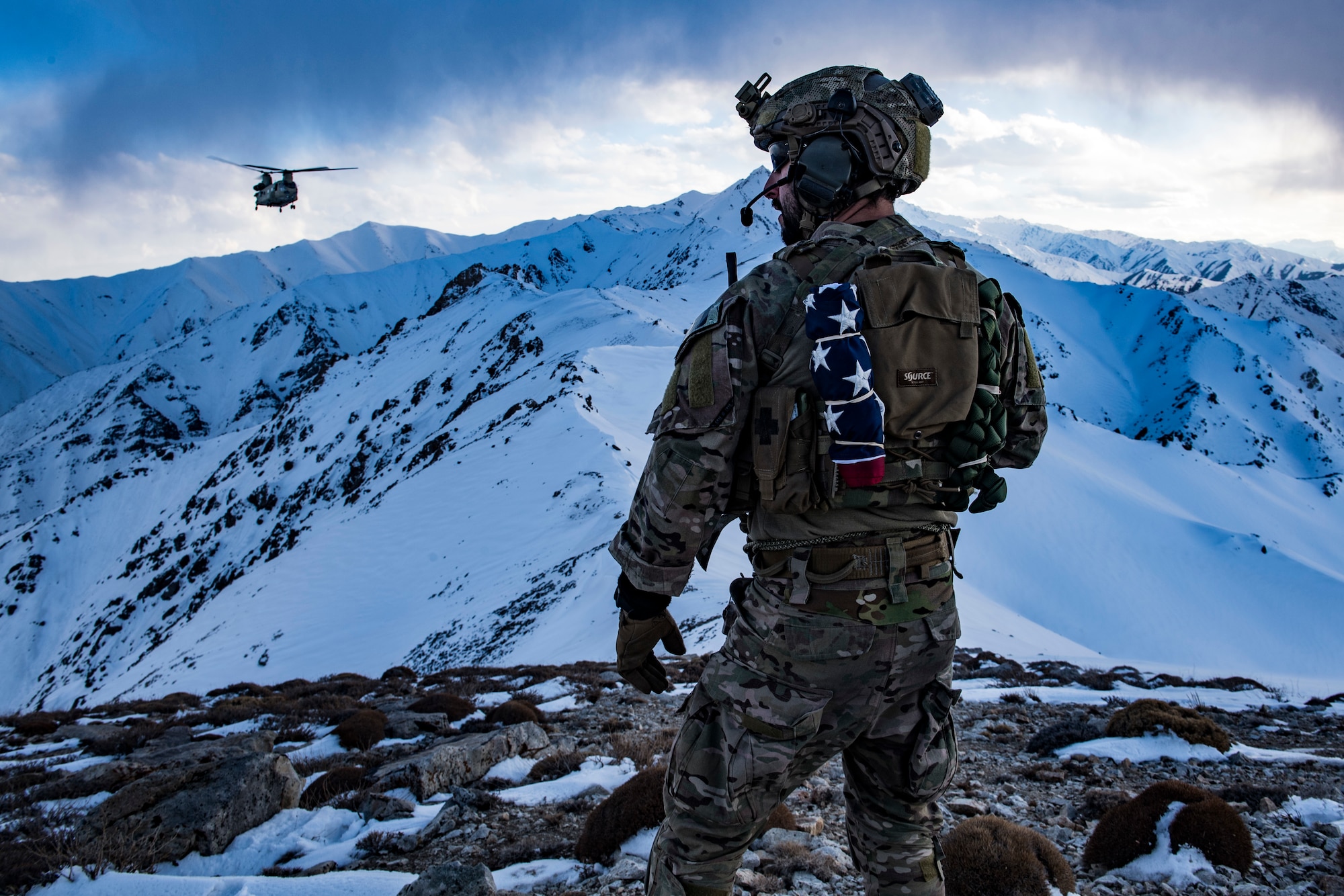 An Air Force pararescueman, assigned to the 83rd Expeditionary Rescue Squadron, communicates with an Army Task Force Brawler CH-47F Chinook during a training exercise at an undisclosed location in the mountains of Afghanistan, March 14, 2018. The Army crews and Air Force Guardian Angel teams conducted the exercise to build teamwork and procedures as they provide joint personnel recovery capability, aiding in the delivery of decisive airpower for U.S. Central Command. (U.S. Air Force photo by Tech. Sgt. Gregory Brook)