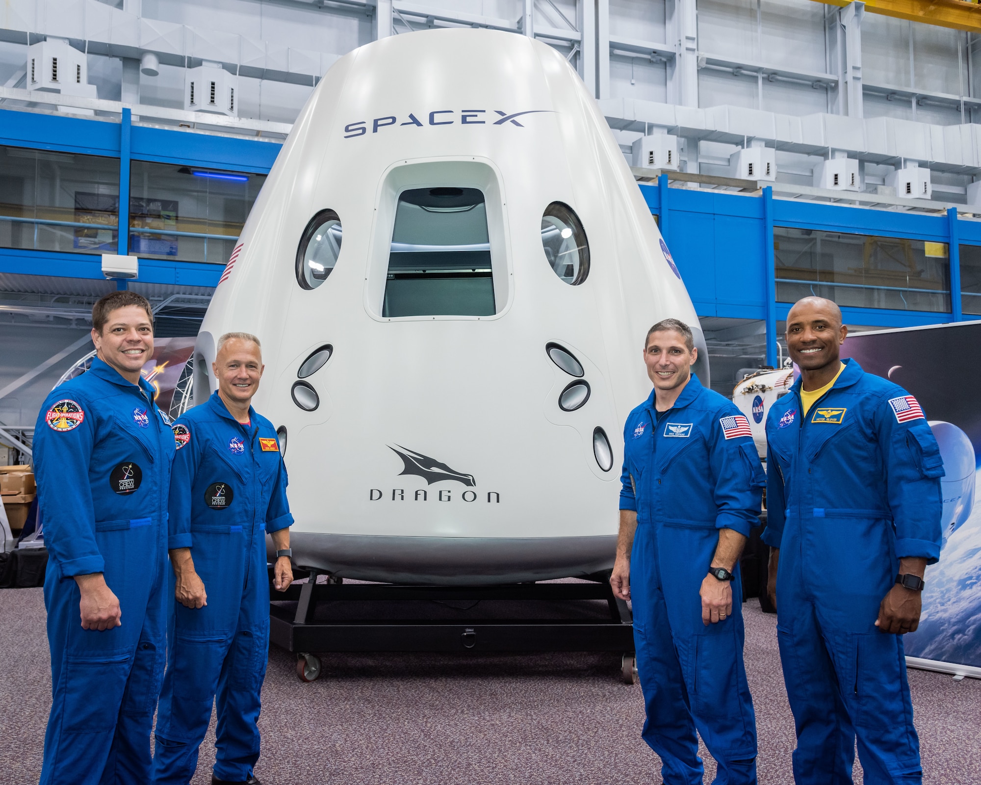 Commercial Crew Astronauts with the Boeing CST-100 and SpaceX Dragon mockups.  Photo Date: August 2, 2018.  Location: Building 9NW - SVMTF.  Photographer: Robert Markowitz